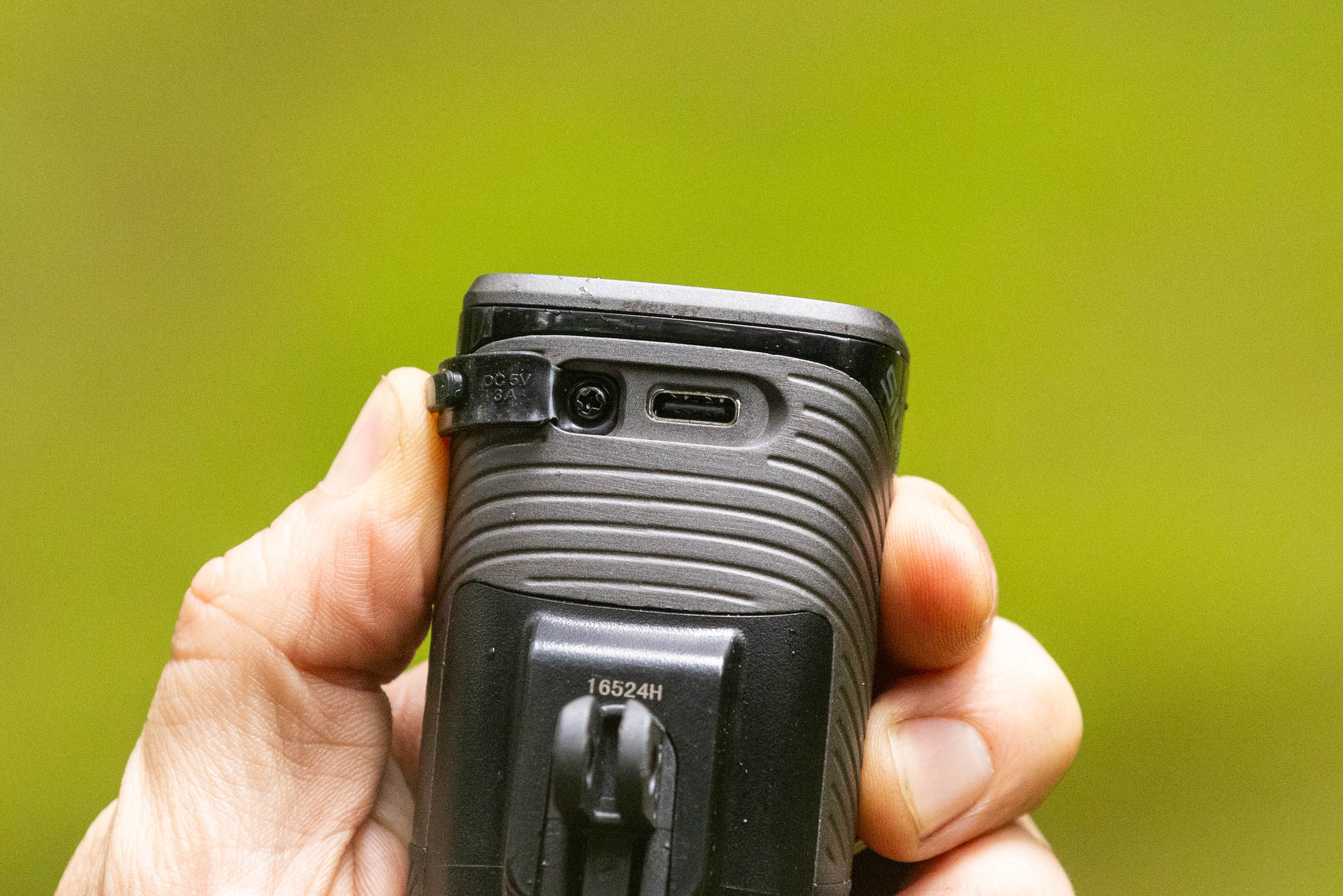 Close-up of the Sigma Buster 1600 front light showing its USB-C charging port and rubber protective cover.
