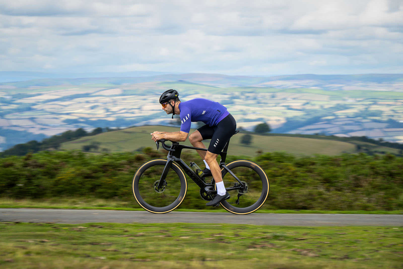 Male cyclist in blue top riding the Cervélo S5 2025 (Dura-Ace Di2) aero road bike