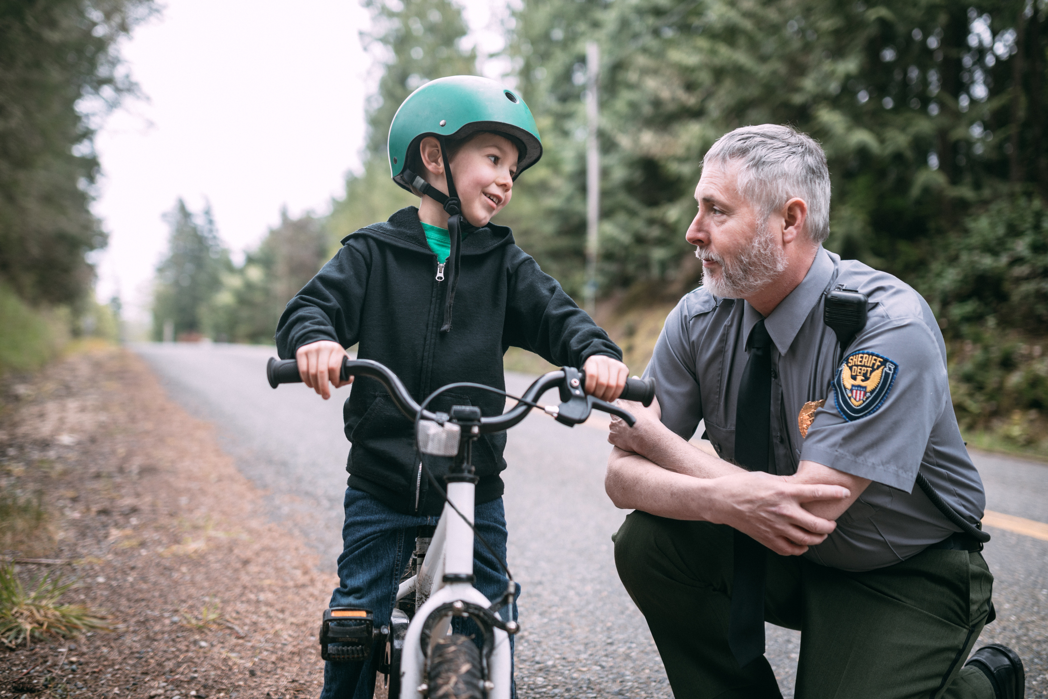 Police Officer Talking to Child on Bike Police Officer Talking to Child on Bike