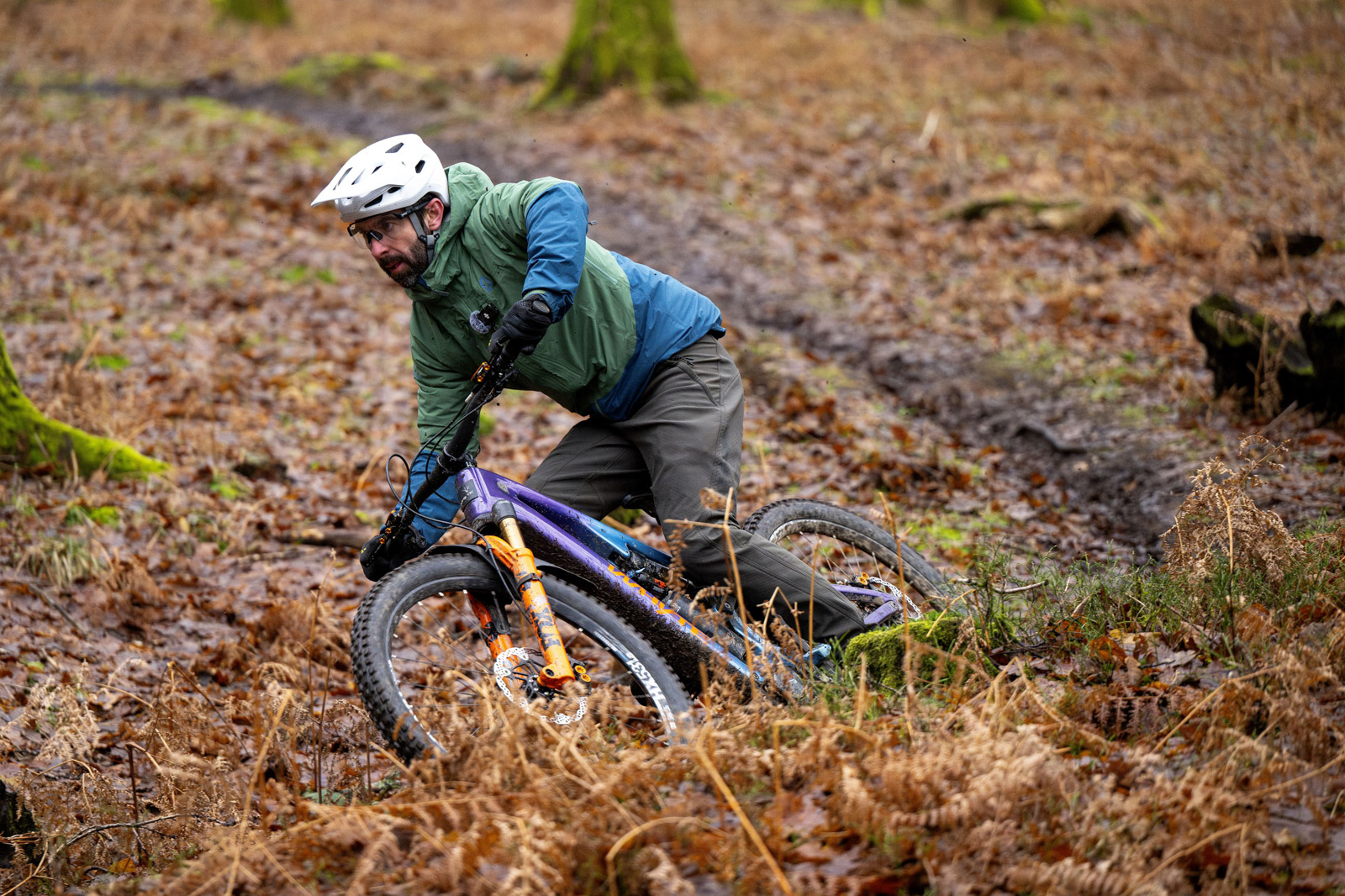 Male rider in green and blue top riding the Whyte ELyte EVO Stag Works electric mountain bike