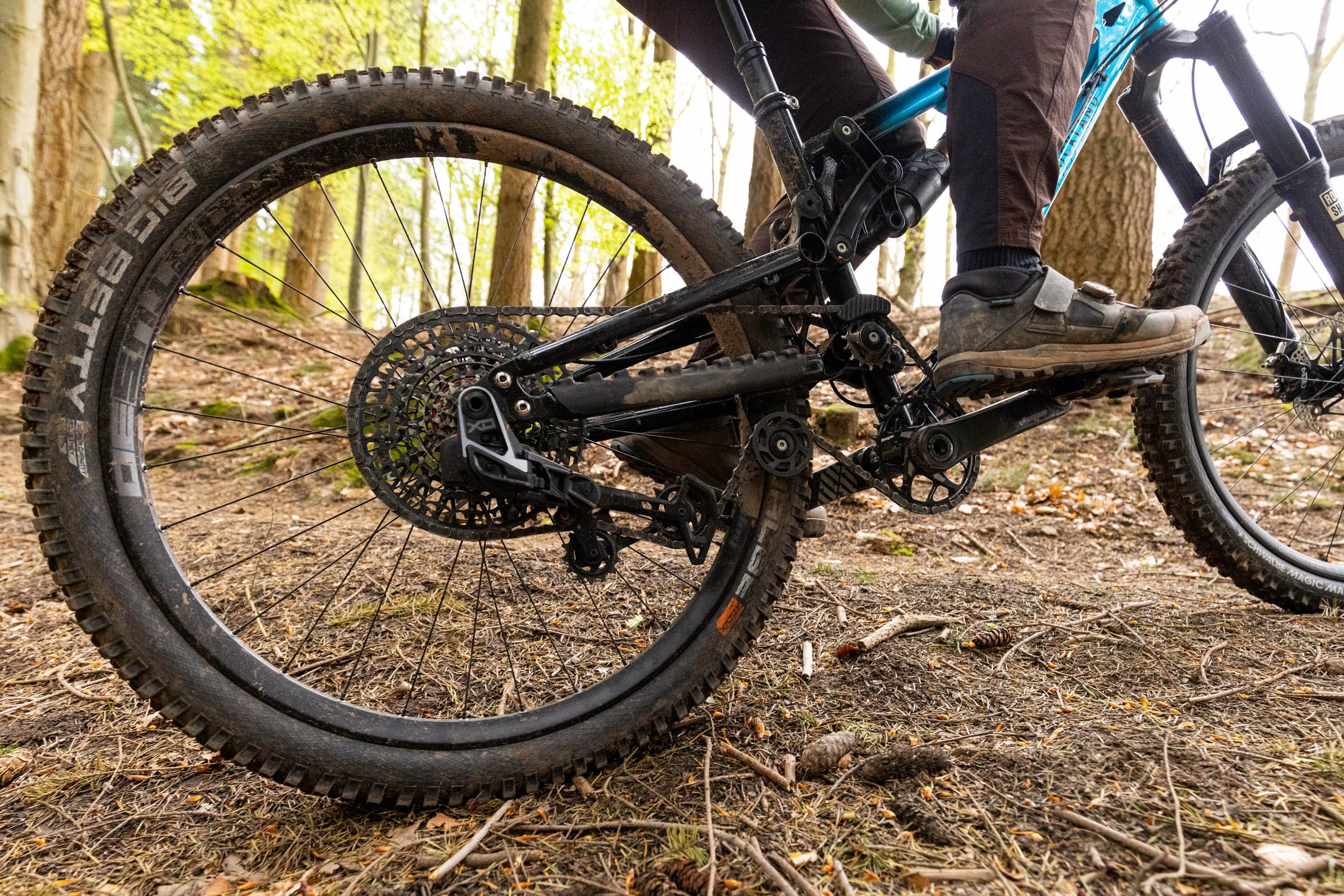 Close-up of the Auckland Cycle Works Marra rear wheel, drivetrain, idler pulleys and rider&rsquo;s foot on the pedal