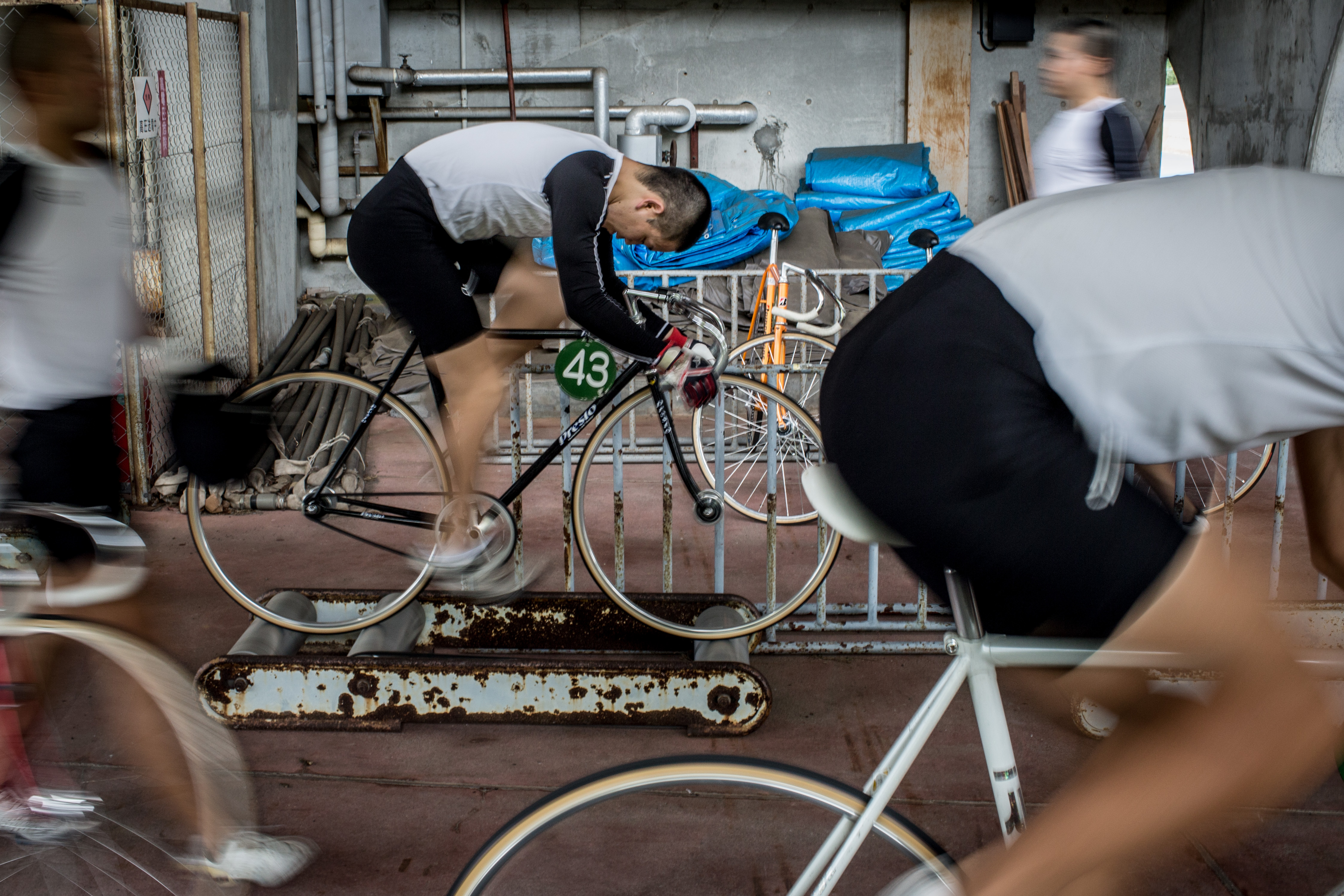 IZU, JAPAN - JULY 08: Keirin students train on rollers at the Nihon Keirin Gakkou (Japan Keirin School) on July 8, 2015 in Izu, Japan. Keirin is a form of cycle racing developed in Japan around 1948 for gambling purposes and has since become extremely popular. It is one of only four sports that patrons are allowed to bet on. In 1957 the Japanese Keirin Association was founded establishing a uniform system for the sport. Today riders must complete study at the Japan Keirin School. For riders accepted to the school, they take on an extremely strict, 15hr, six day a week training schedule, before being eligible to graduate as approved professional Keirin riders able to compete in Japan's professional Keirin league. There are over 3000 registered riders in Japan and salaries for top riders can bring in as much as 2million USD, average riders can bring in salaries of 100,000USD. Despite its popularity, Keirin racing has seen a steady decline since the 1990's with attendance and revenue declining consistently. With Japan's ageing population and Keirin seen mainly as a gambling activity, it's fan base is made up primarily of punters over the age of 50. Attracting young fans is a crucial step to reinvigorating the sport. However the lack of interest from young Japanese in sports betting and the popularity of baseball and football, attracting younger spectators is an up hill battle. The JKA has taken steps to attract younger fans, In 2012 women's racing was reintroduced under the name, Girl's Keirin and promoted with a national TV advertising campaign showing riders in high heels and dresses as an attempt to attract younger viewers. With the current debate in Japan over the introduction of casinos and the popularity of Pachinko slot gambling with the younger generation, Keirin racing could see yet another decline. (Photo by Chris McGrath/Getty Images)