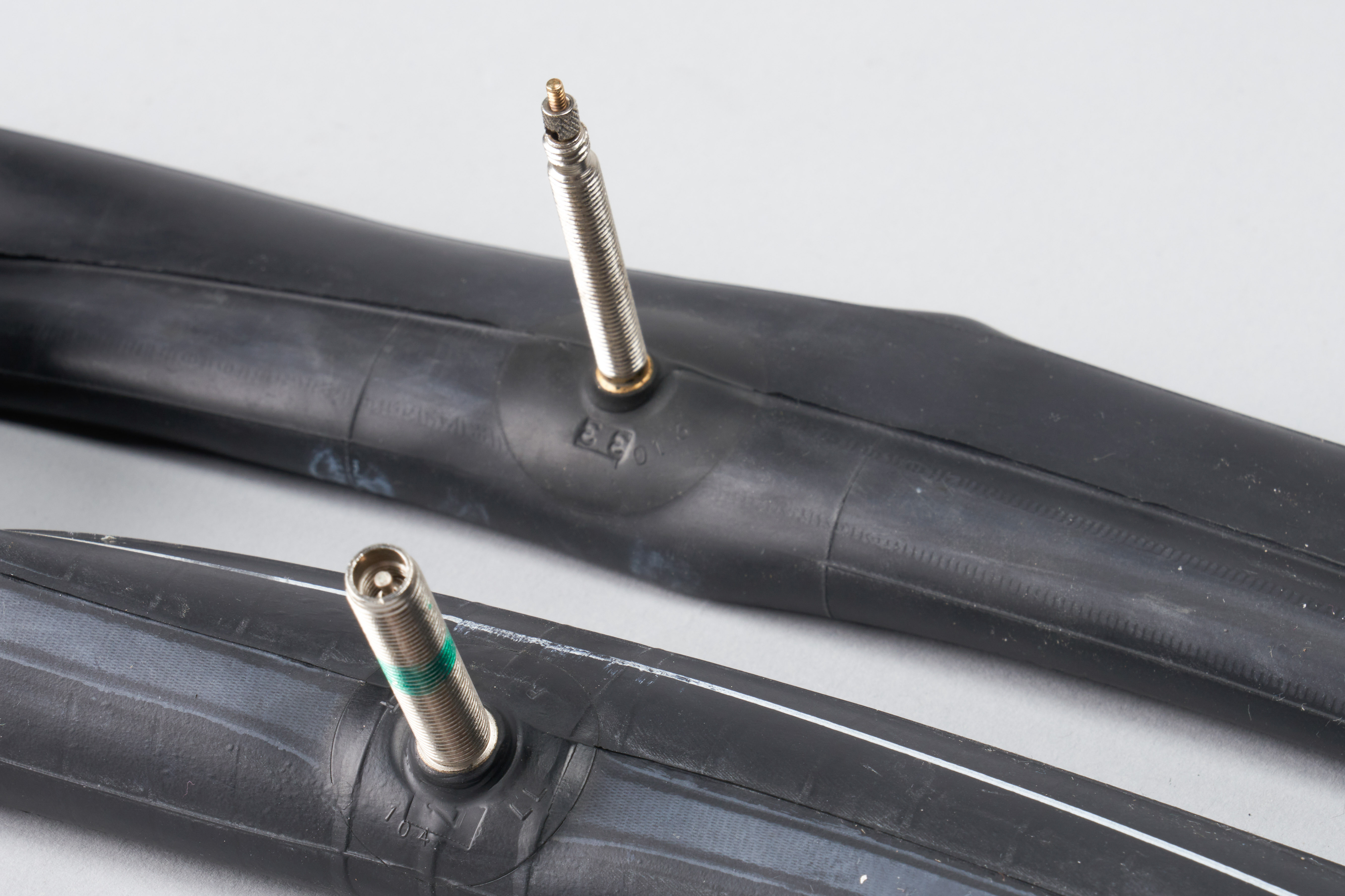 Presta vs Schrader Presta and Schrader valved inner tubes against a white background