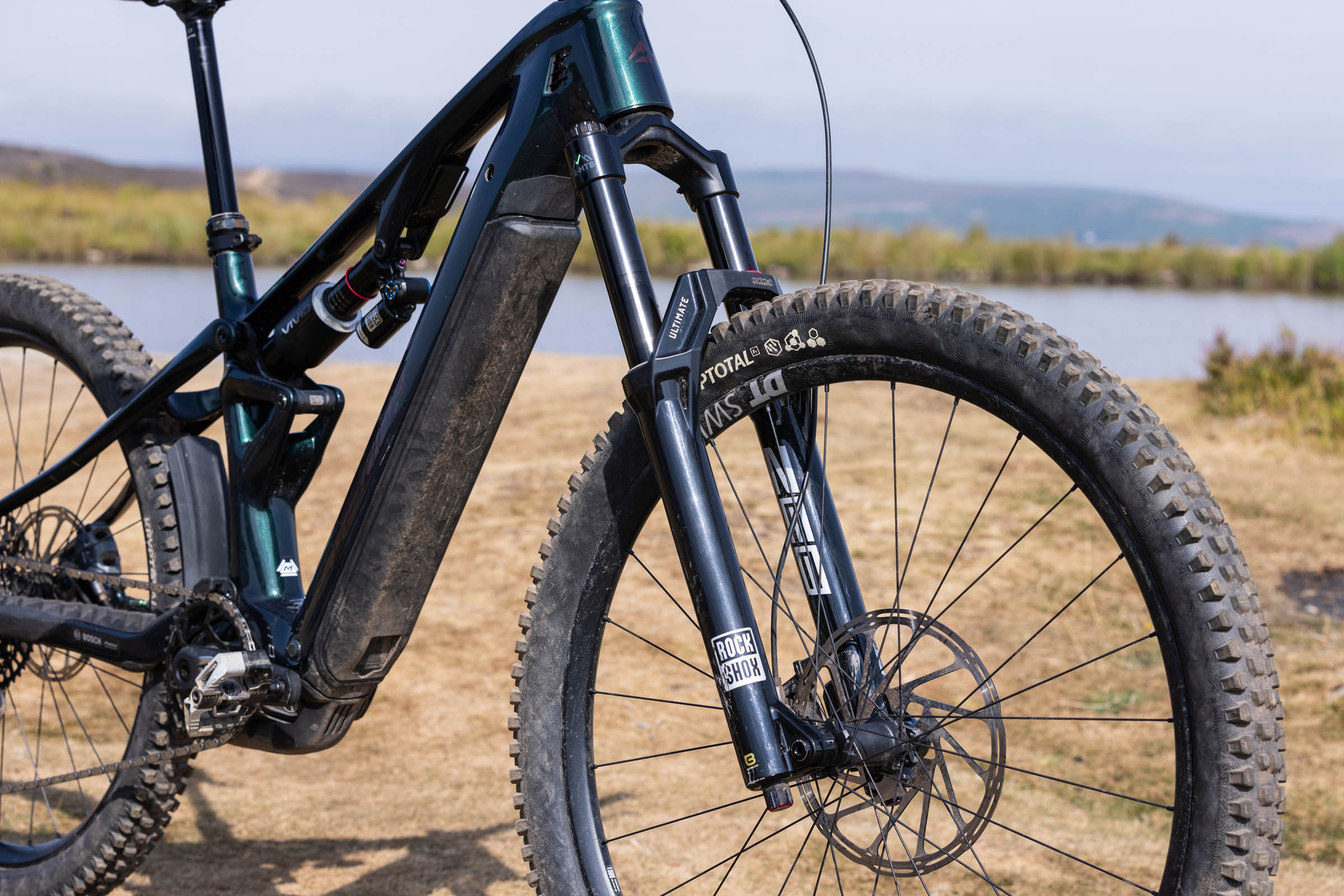 Close-up of the Merida Lithos 8000 down tube, removable Bosch battery and RockShox Zeb Ultimate fork