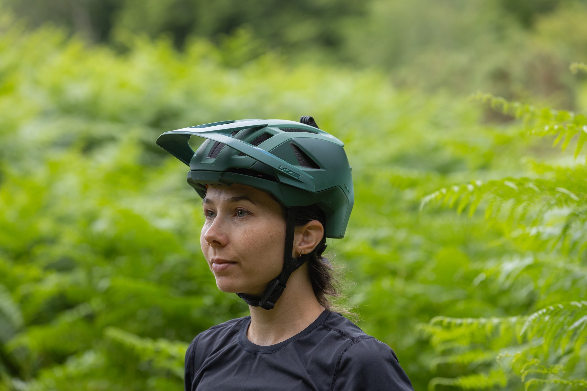 Rider wearing the Lazer Impala KinetiCore trail mountain bike helmet in woodland.