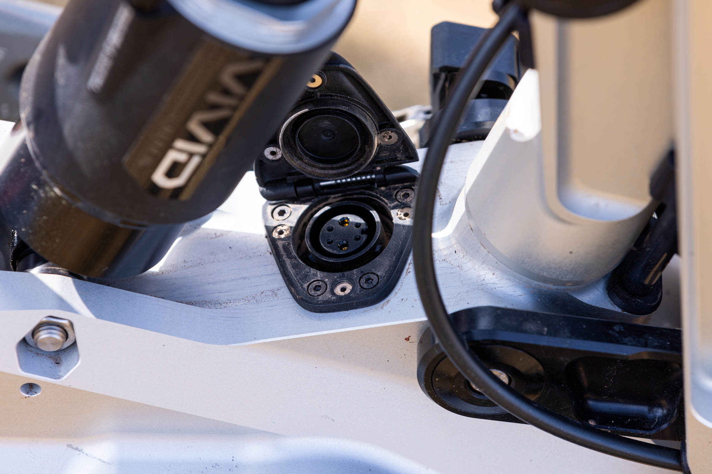 Close-up of the charging port on the Atherton S.170E electric mountain bike with its protective cover open.