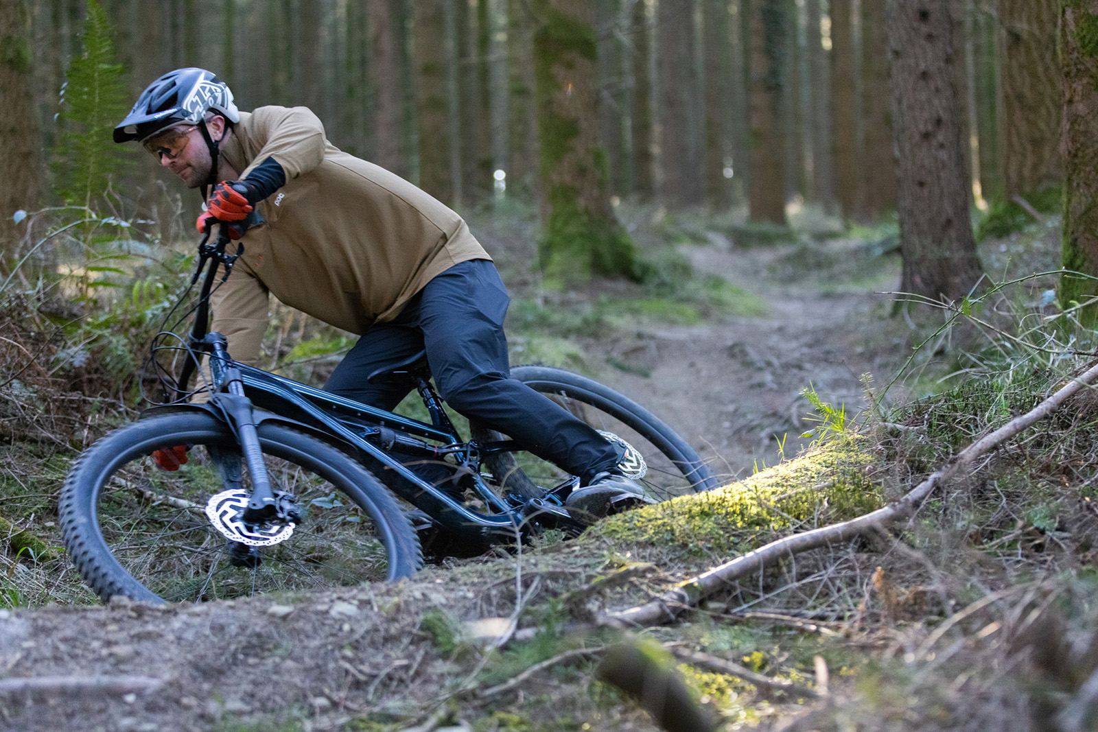 Male rider in brown jacket riding the Calibre Bossnut mountain bike