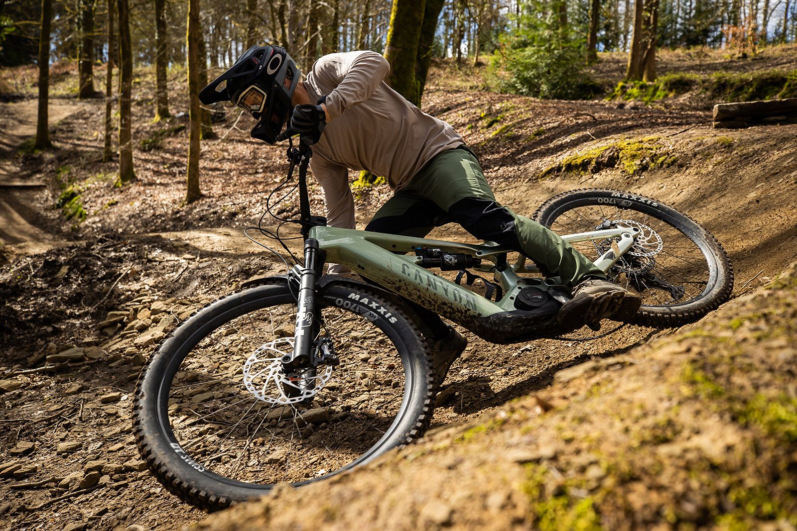 Male riding in light coloured top riding the Canyon Strive:ON CFR full suspension mountain eBike eMTB