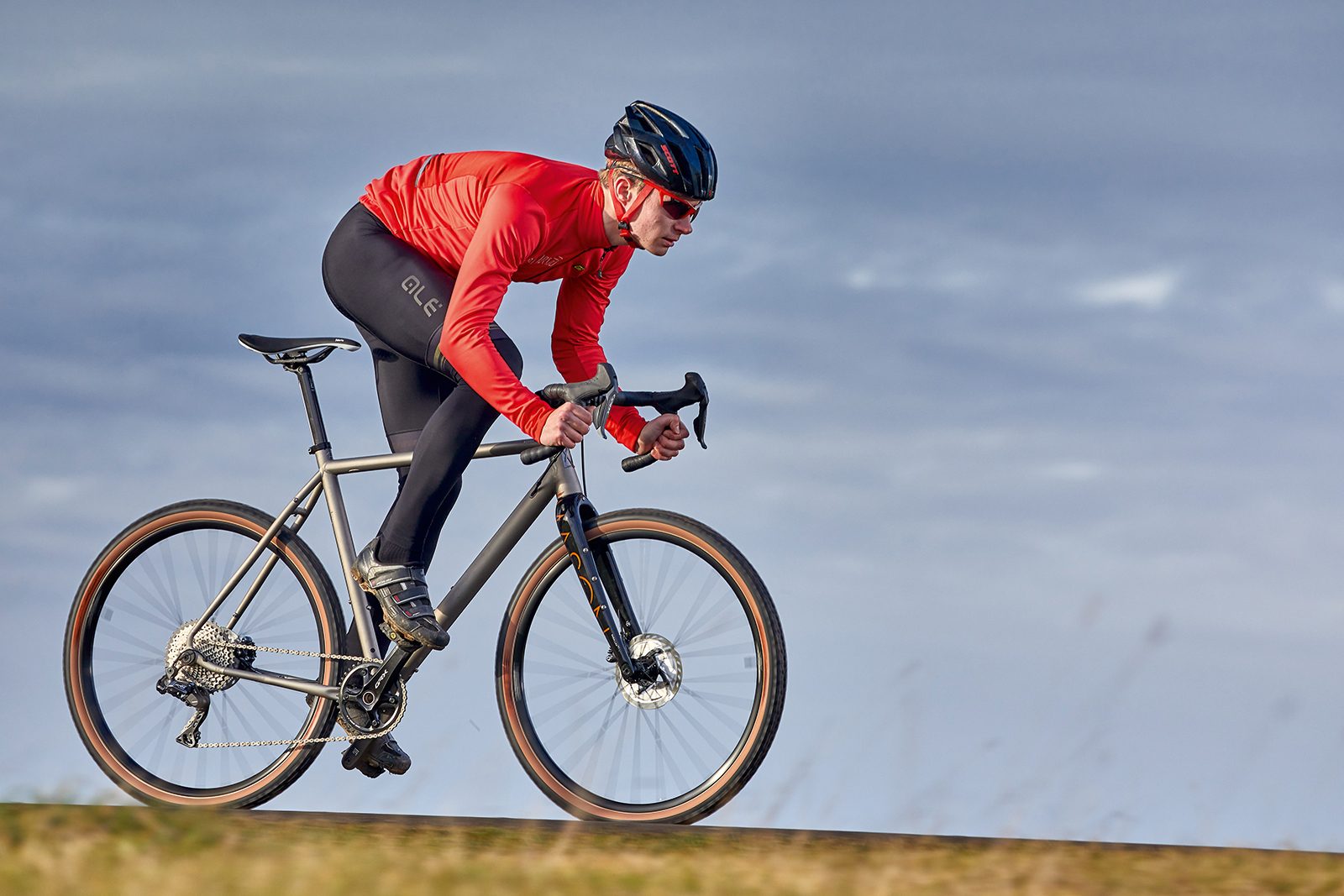 Silver coloured Mason Bokeh Ti road bike being ridden through countryside