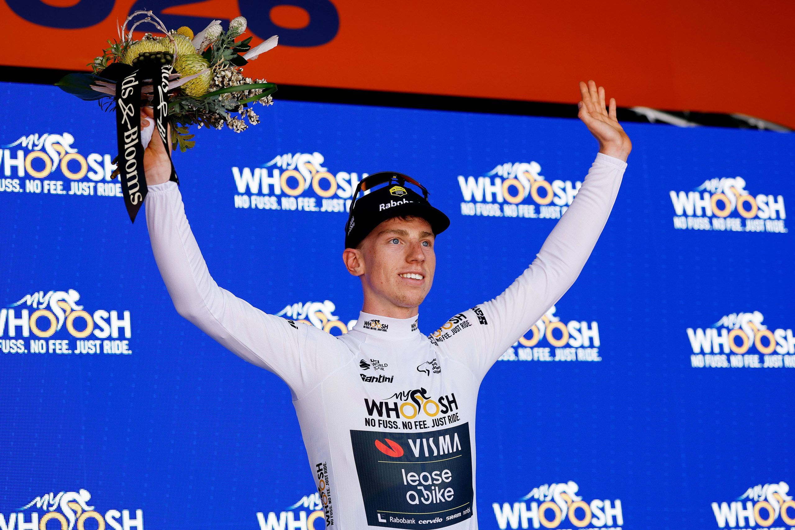 TANUNDA, AUSTRALIA - JANUARY 21: Matthew Brennan of Great Britain and Team Visma | Lease a Bike celebrates at podium as White Best Young Rider Jersey winner during the 26th Santos Tour Down Under 2026, Stage 1 a 120.6km stage from Tanunda to Tanunda on January 21, 2026 in Tanunda, Australia. (Photo by Con Chronis/Getty Images)