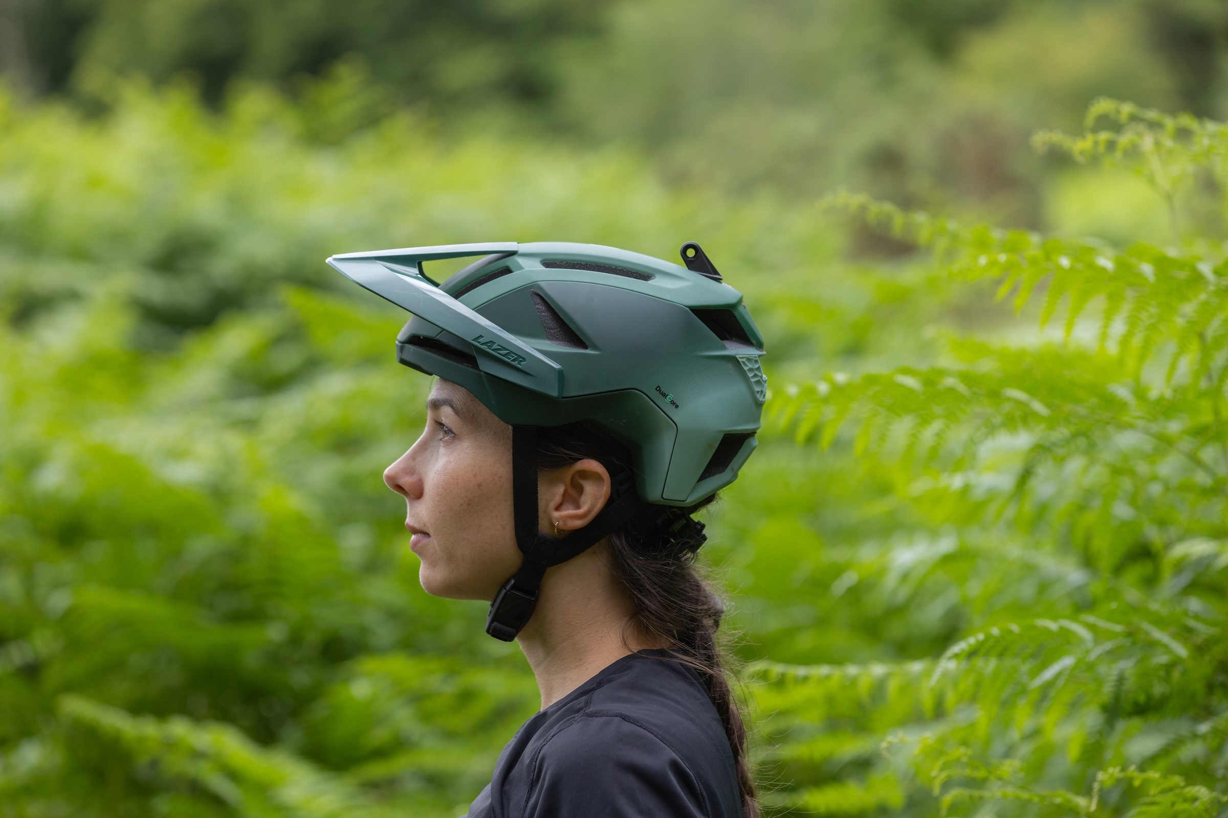 Side profile of a rider wearing the Lazer Impala KinetiCore trail mountain bike helmet.
