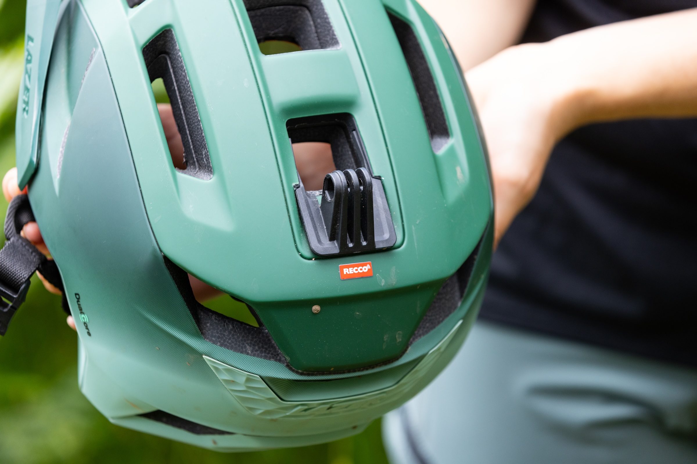 Close-up of the Lazer Impala KinetiCore helmet showing the RECCO reflector and breakaway accessory mount.