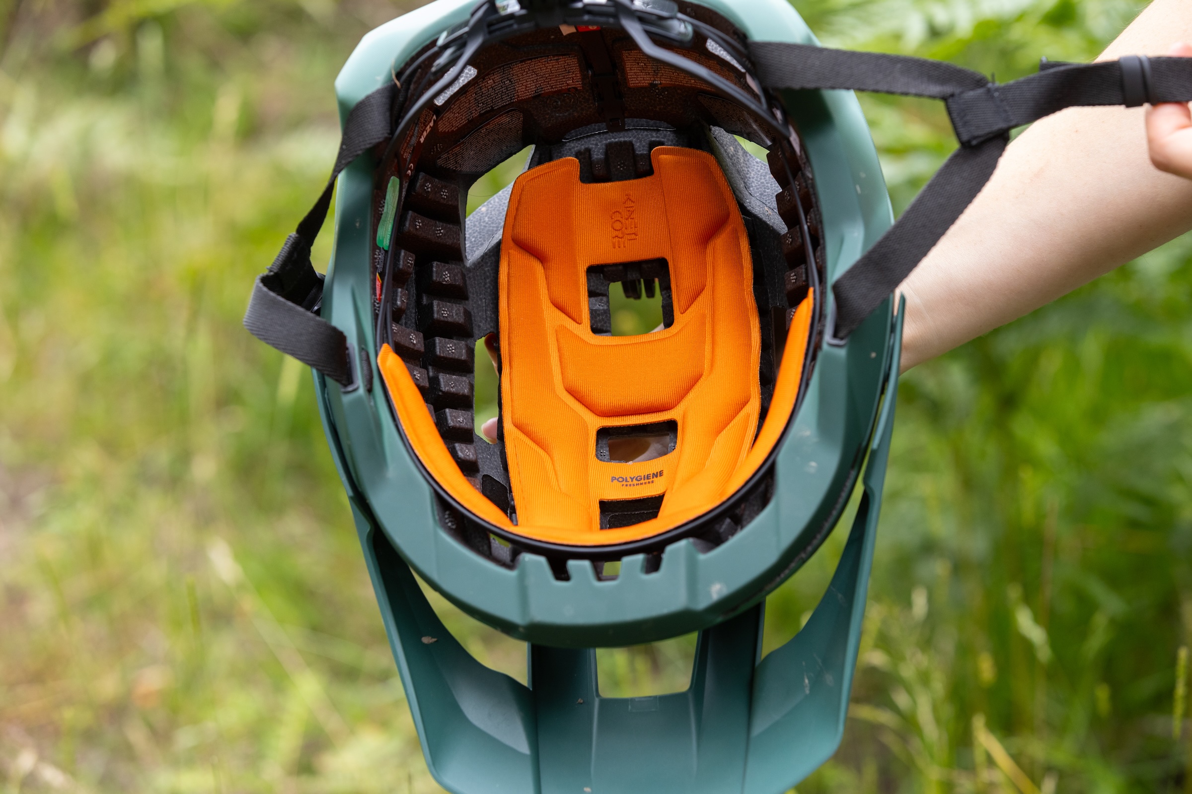 Inside view of the Lazer Impala KinetiCore helmet showing its orange padding and visible EPS crumple zones.