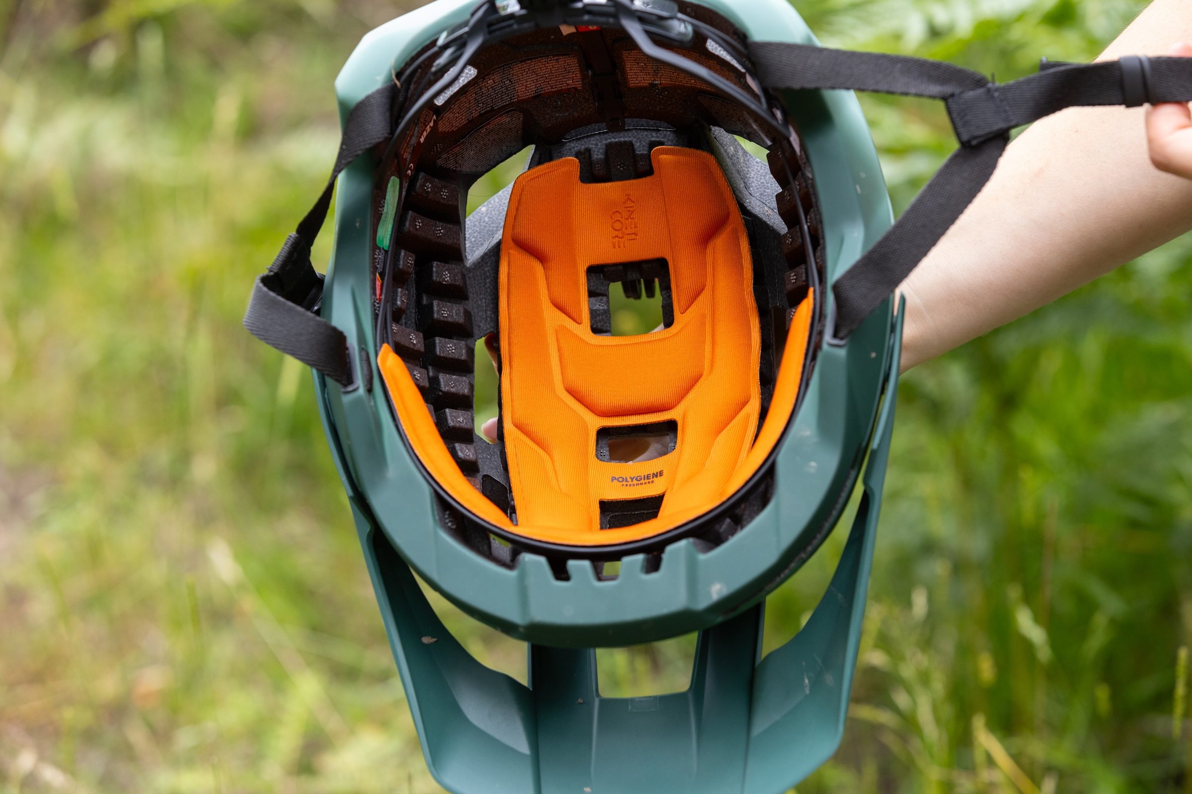 Inside view of the Lazer Impala KinetiCore helmet showing its orange padding and visible EPS crumple zones.