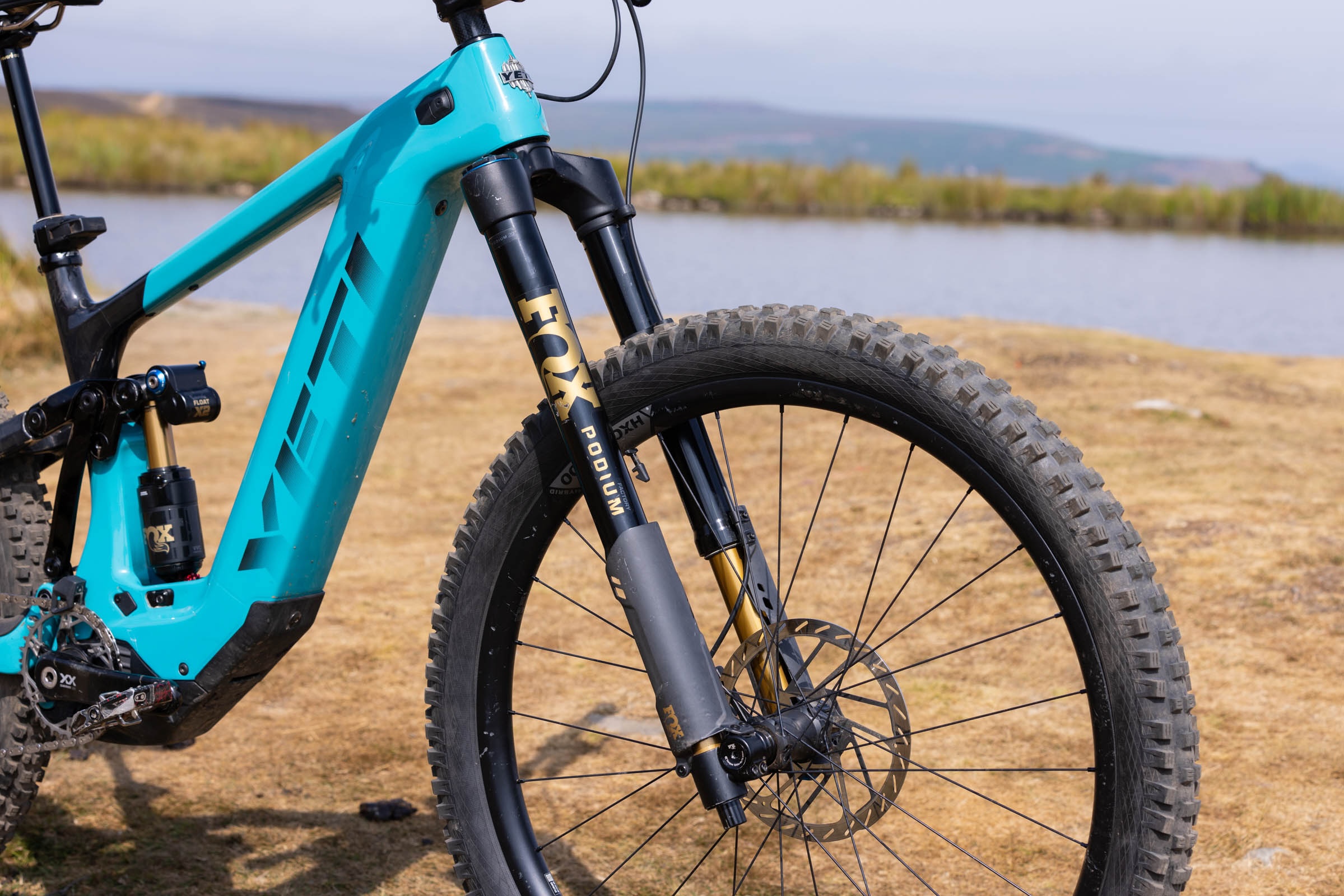 Close-up of the Fox Podium Factory fork and front wheel fitted to the blue Yeti LTe T4