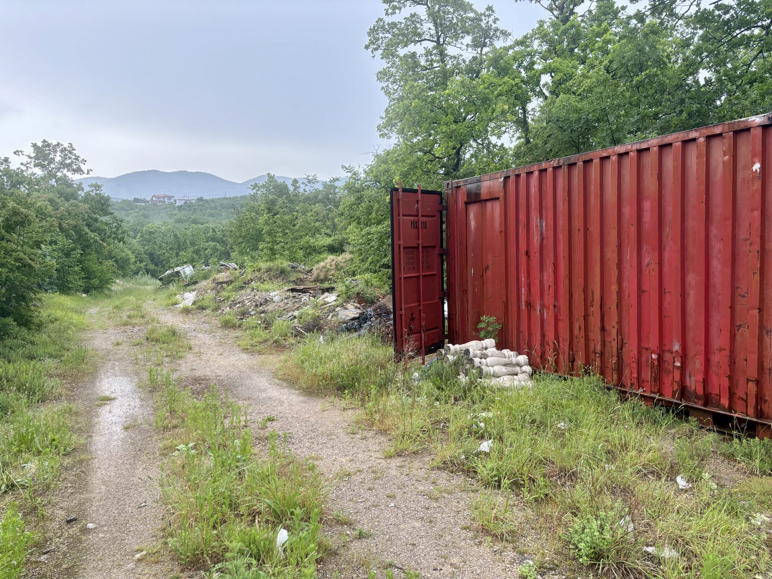 Storage cabin by a gravel road. 