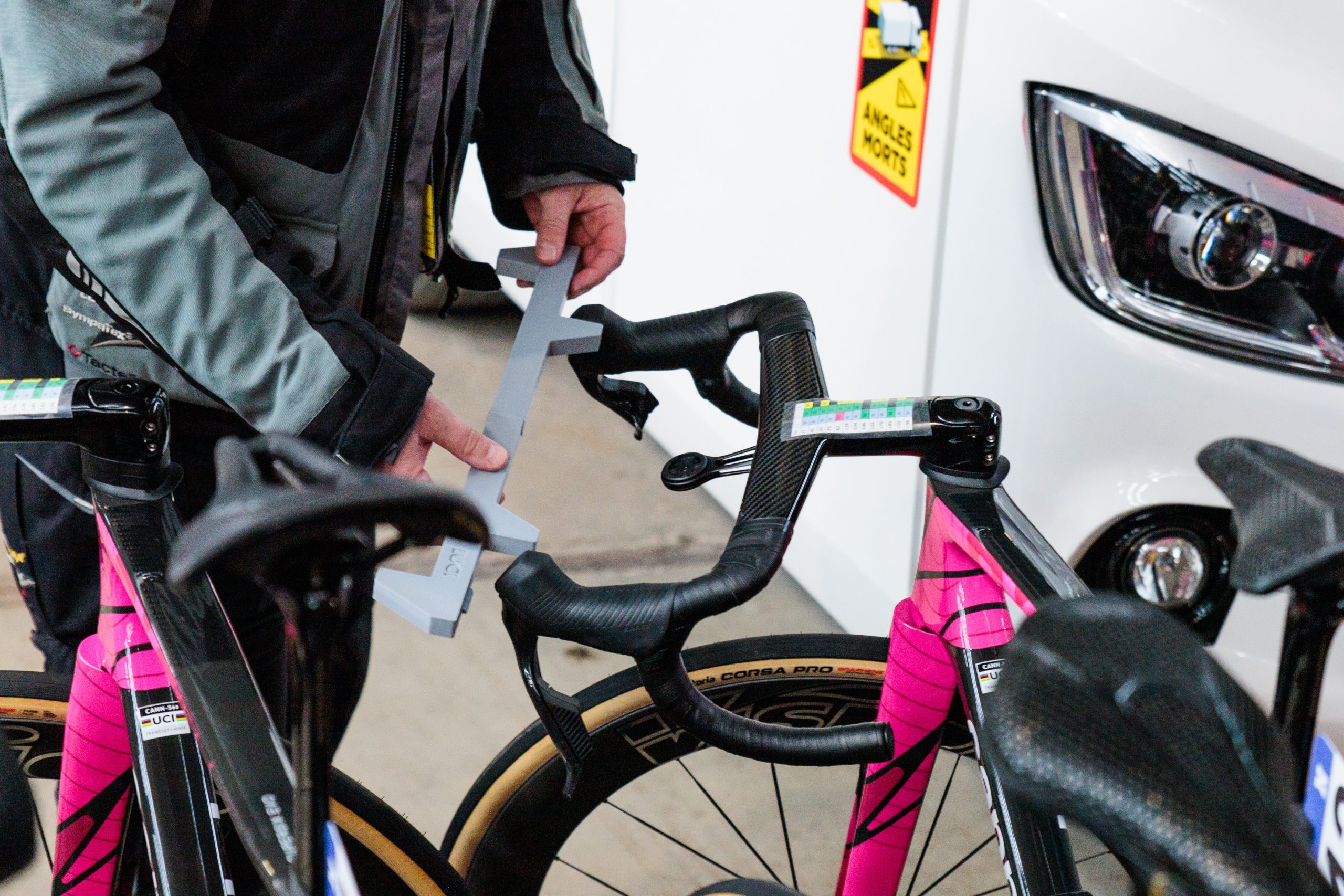 UCI commissaire checking handlebar widths before the 2026 Omloop Het Nieuwsblad