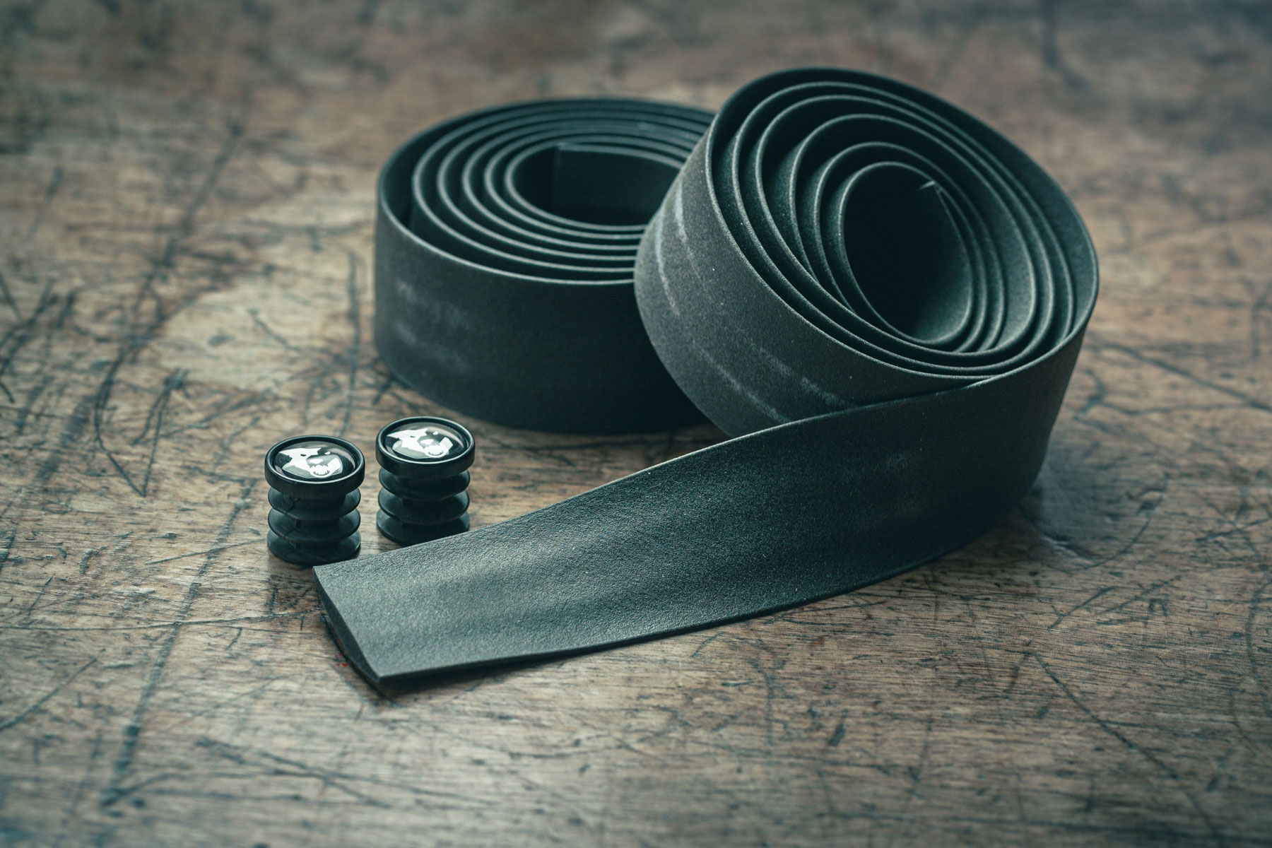 Wolftooth Supple handlebar tape on wooden surface.