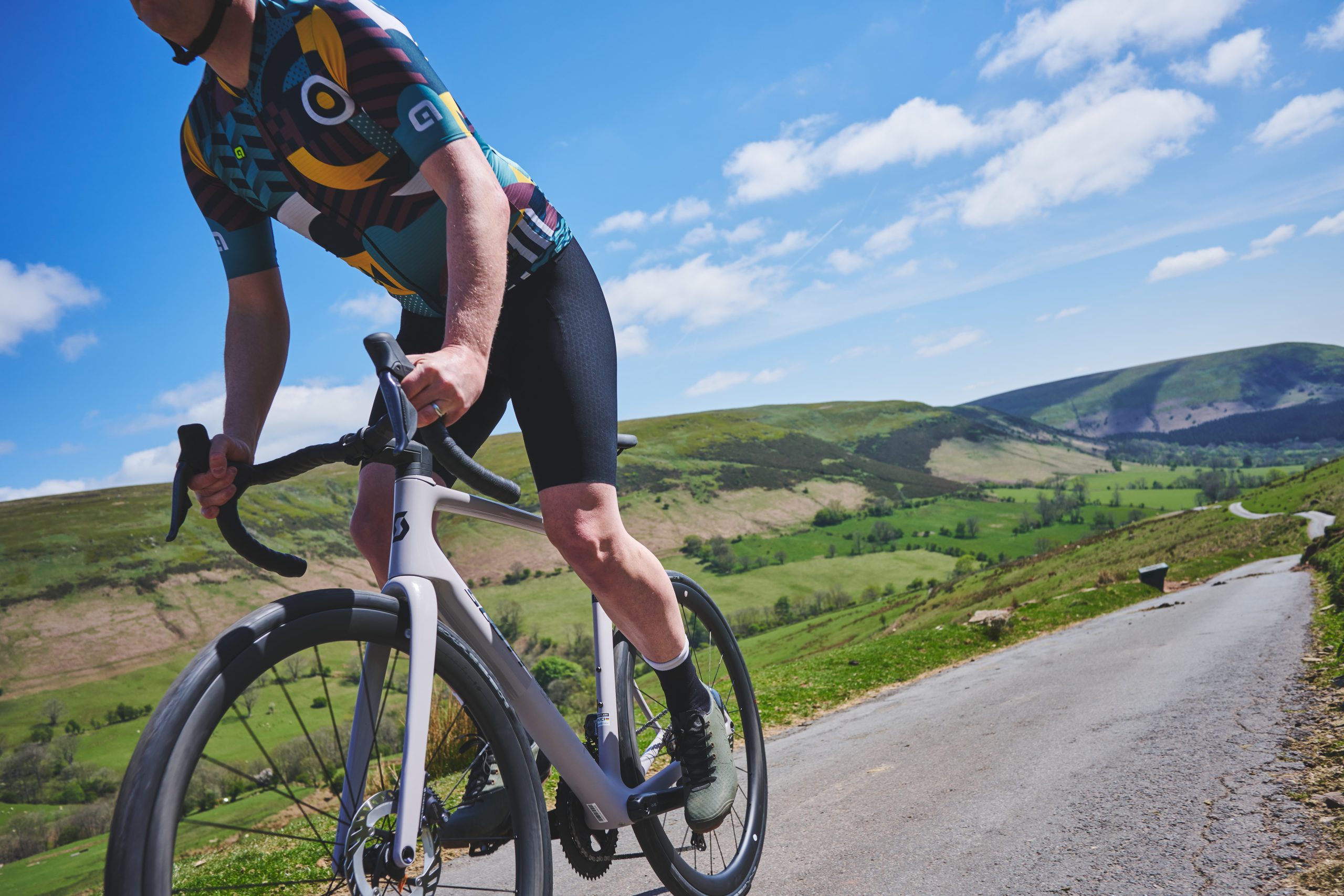 Person riding Scott road bike on English country road.
