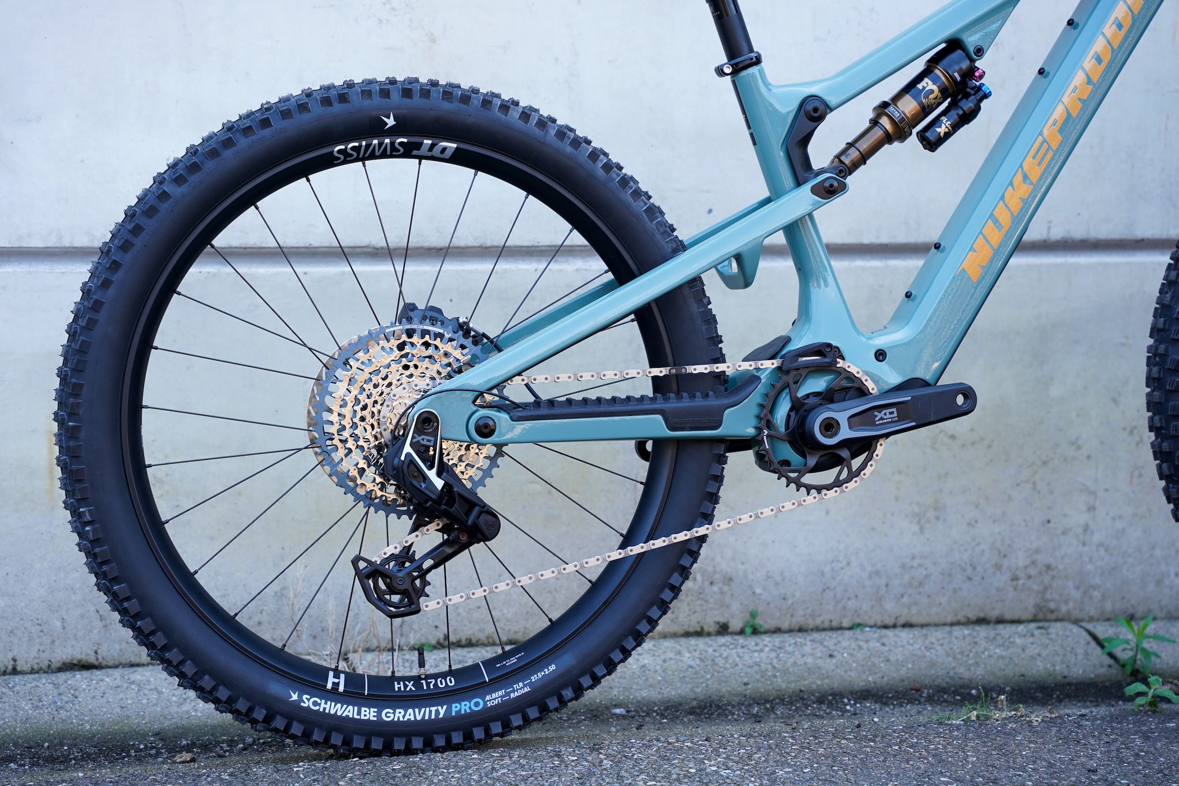 Close-up of the rear wheel, drivetrain and suspension on the Nukeproof Kilowatt Carbon Factory electric mountain bike.