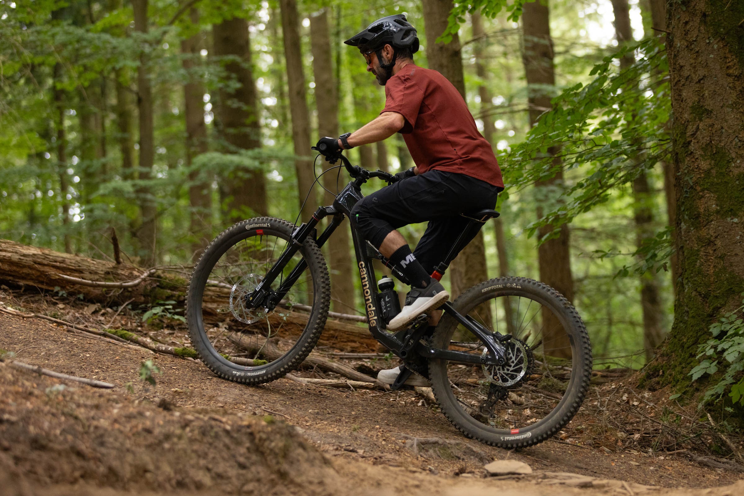 Rider climbing a section of singletrack trail aboard a Cannondale Bad Habit 1.