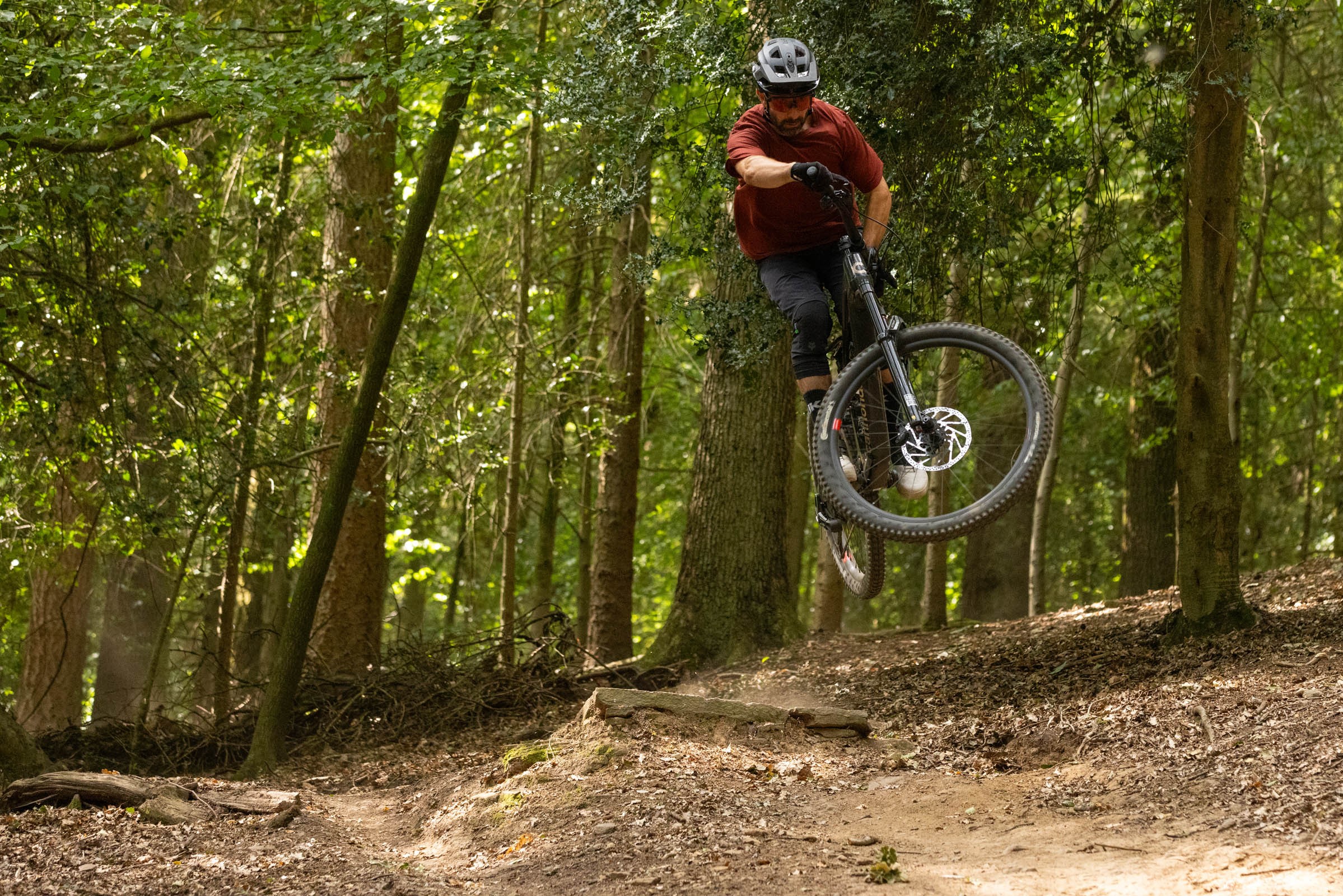 Rider jumping and turning their handlebars/front wheel in the air.