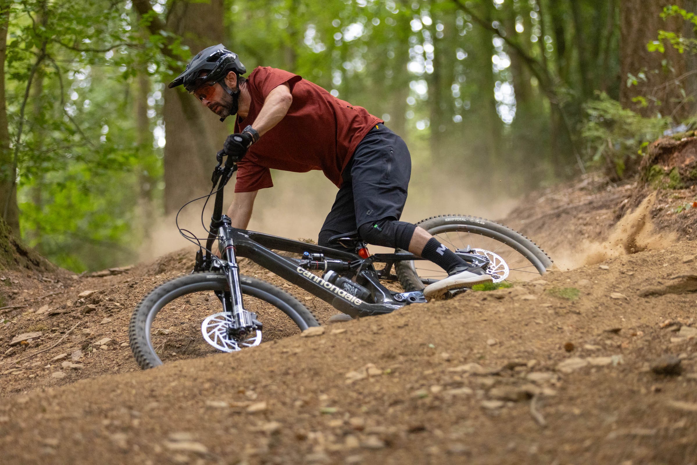 Rider sliding through dusty righthand turn aboard a Cannondale Bad Habit 1.