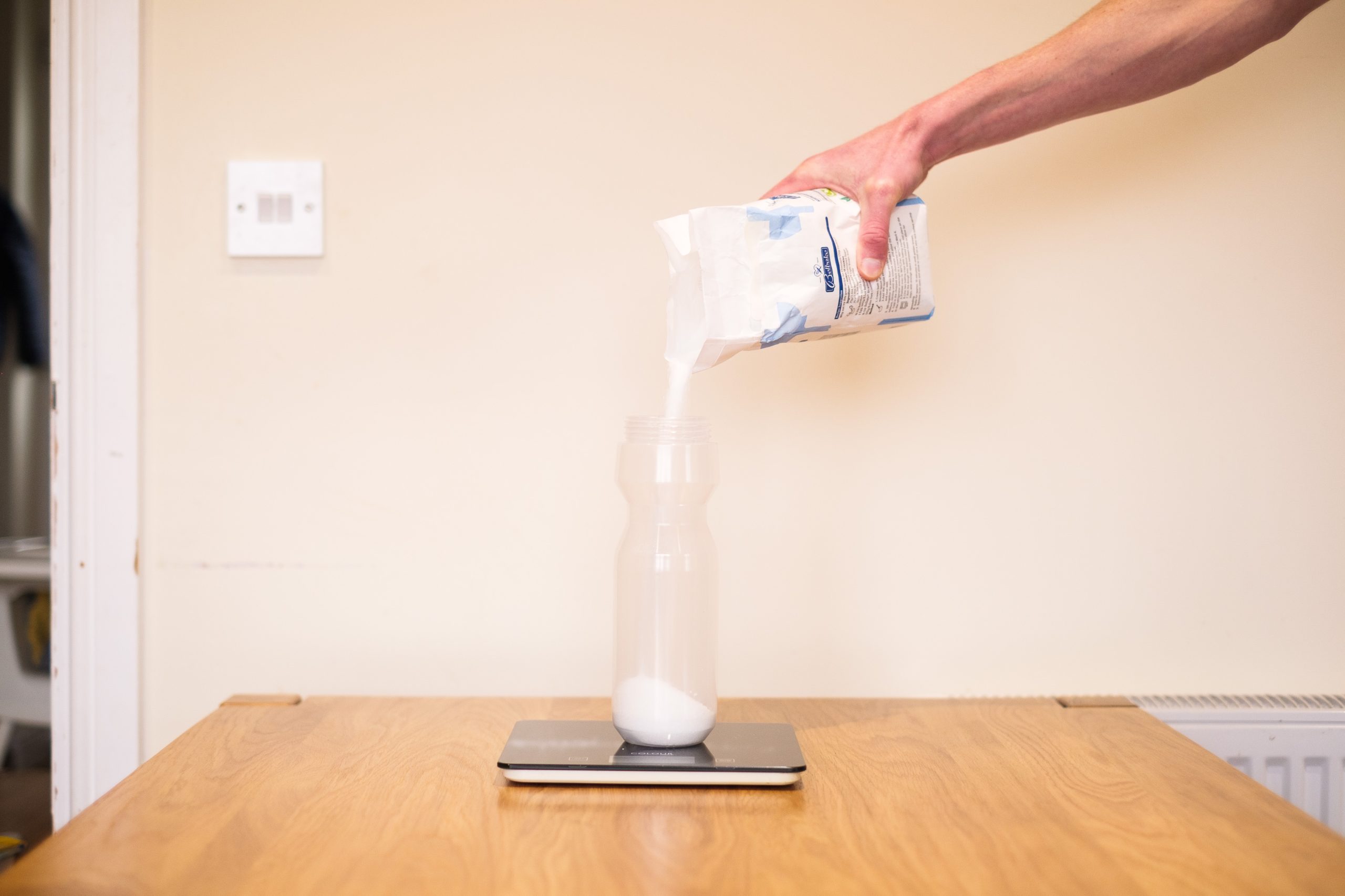 Pouring sugar into a cycling water bottle