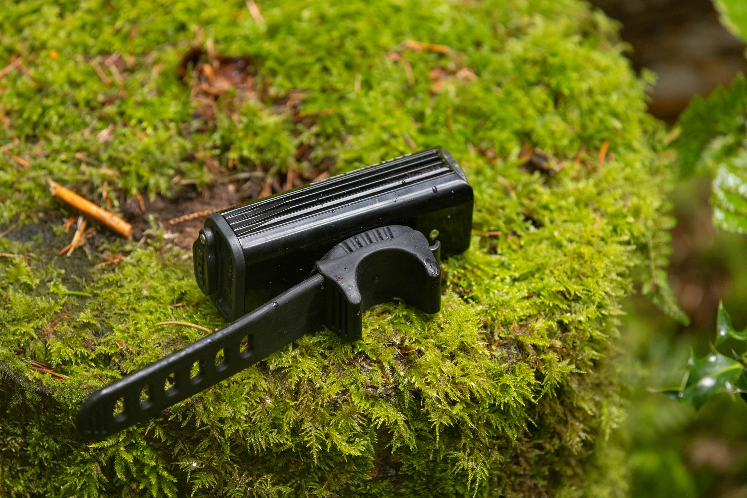 Rear view of the Lezyne Super Drive 1800+ Smart front light showing its rubber handlebar strap and finned black body.