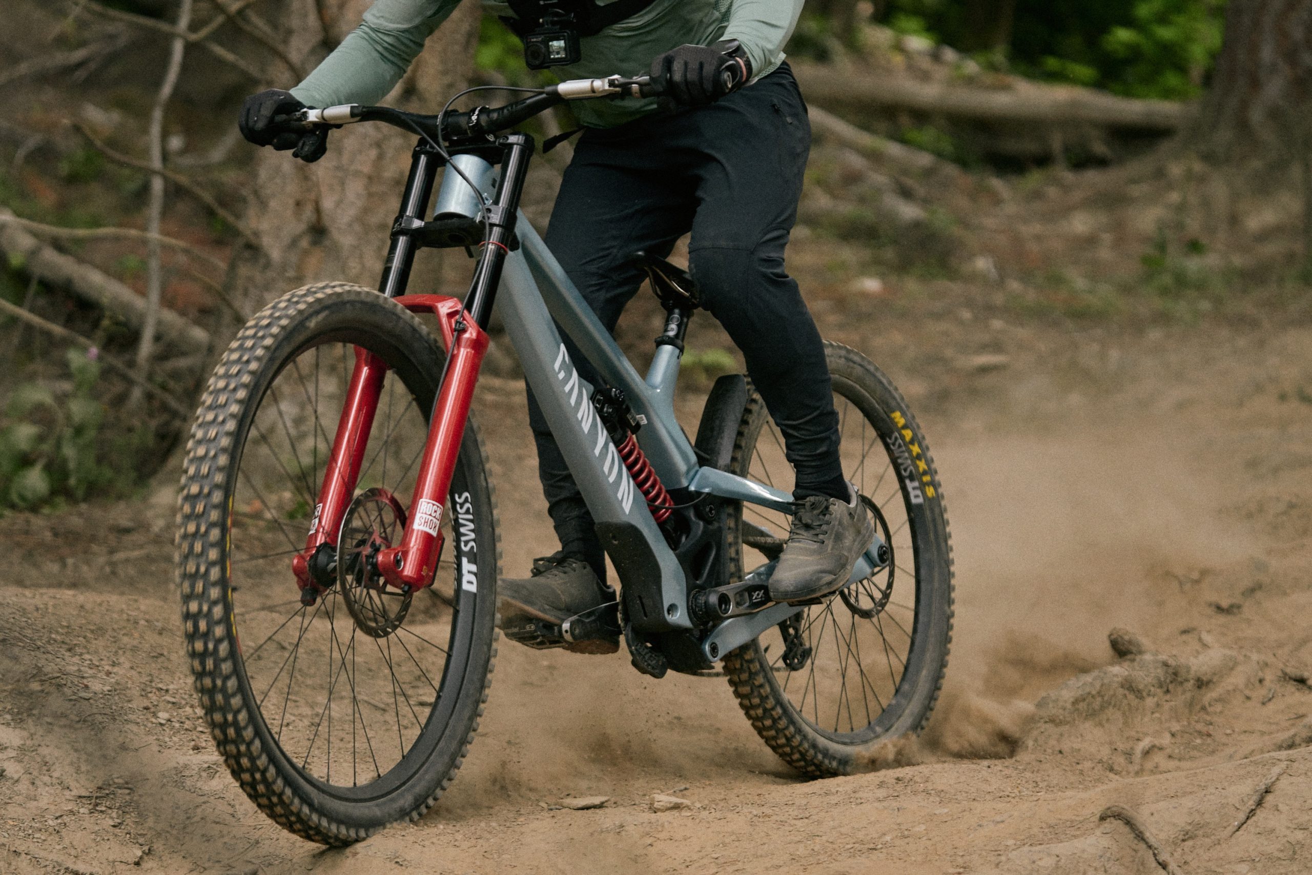 Cropped shot showing downhill bike on dusty, rough trail in Queenstown Bikepark, New Zealand.