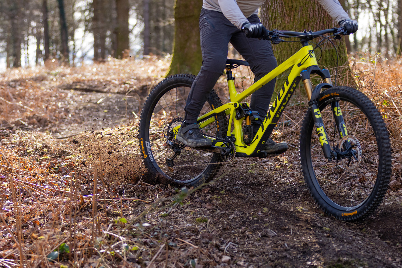 Make rider in grey top riding the Pivot Firebird Pro XT/XTR Air full suspension mountain bike
