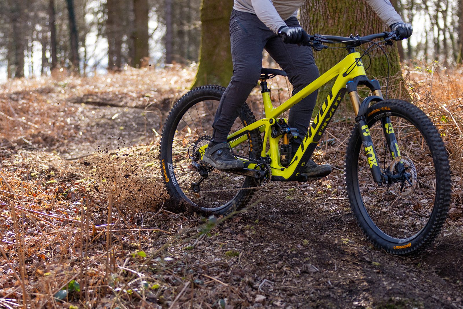 Make rider in grey top riding the Pivot Firebird Pro XT/XTR Air full suspension mountain bike