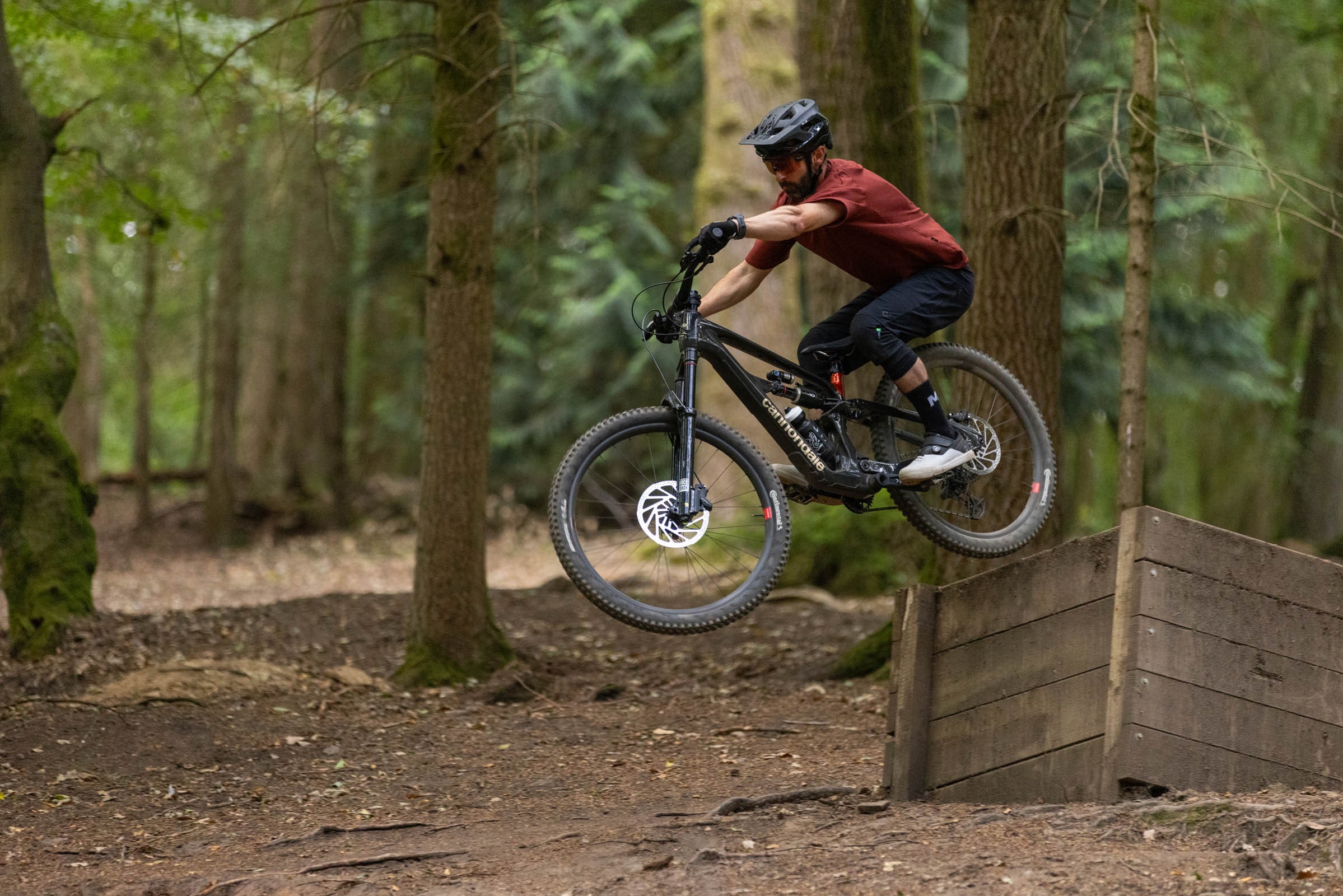 Rider jumping off a drop on the trail aboard a Cannondale Bad Habit 1.