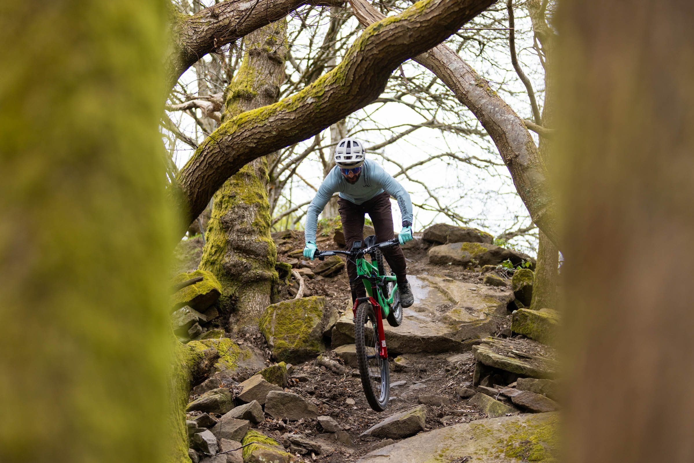Riding descending down steep, rocky chute on green Specialized Stumpjumper 15 Expert bike.