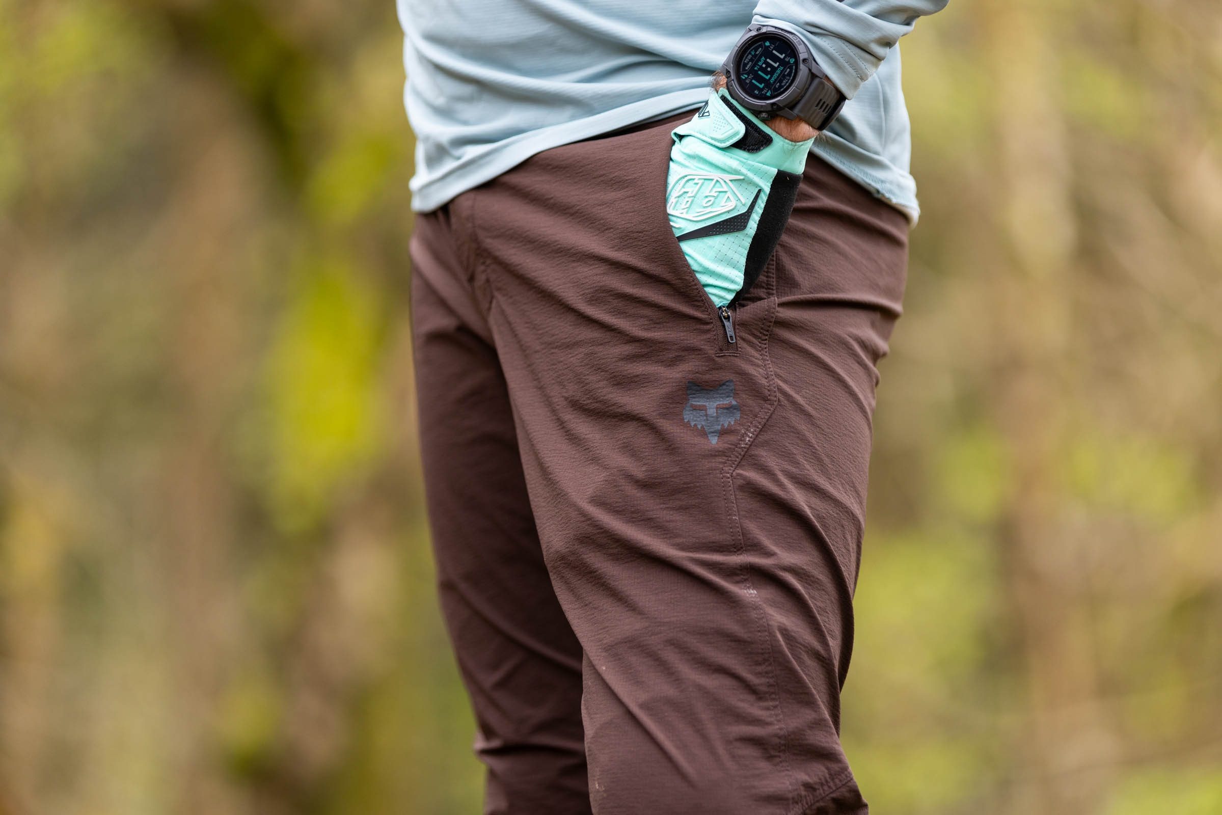 Rider putting hand into one of the two hip pockets featured on the Fox Ranger trousers.
