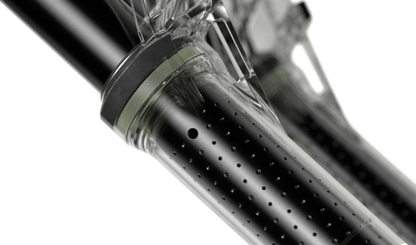 Tightly cropped shot of clear suspension fork showing dimples and holes in the upper tubes. These are known as RockShox ButterWagon Tech and breather holes.
