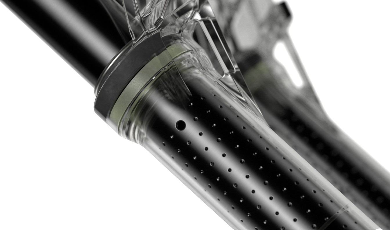 Tightly cropped shot of clear suspension fork showing dimples and holes in the upper tubes. These are known as RockShox ButterWagon Tech and breather holes.