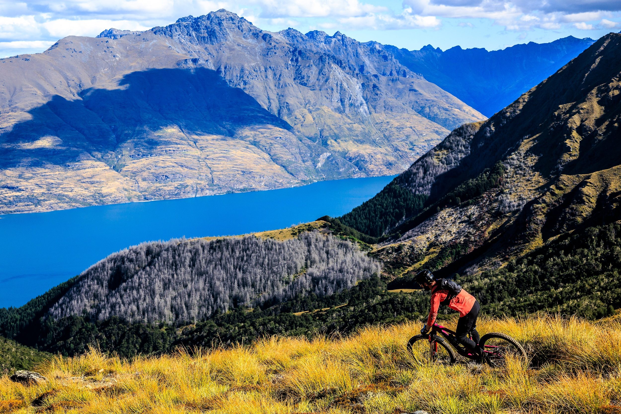 Rider descending down into the valley above the lake in Queenstown, New Zealand.