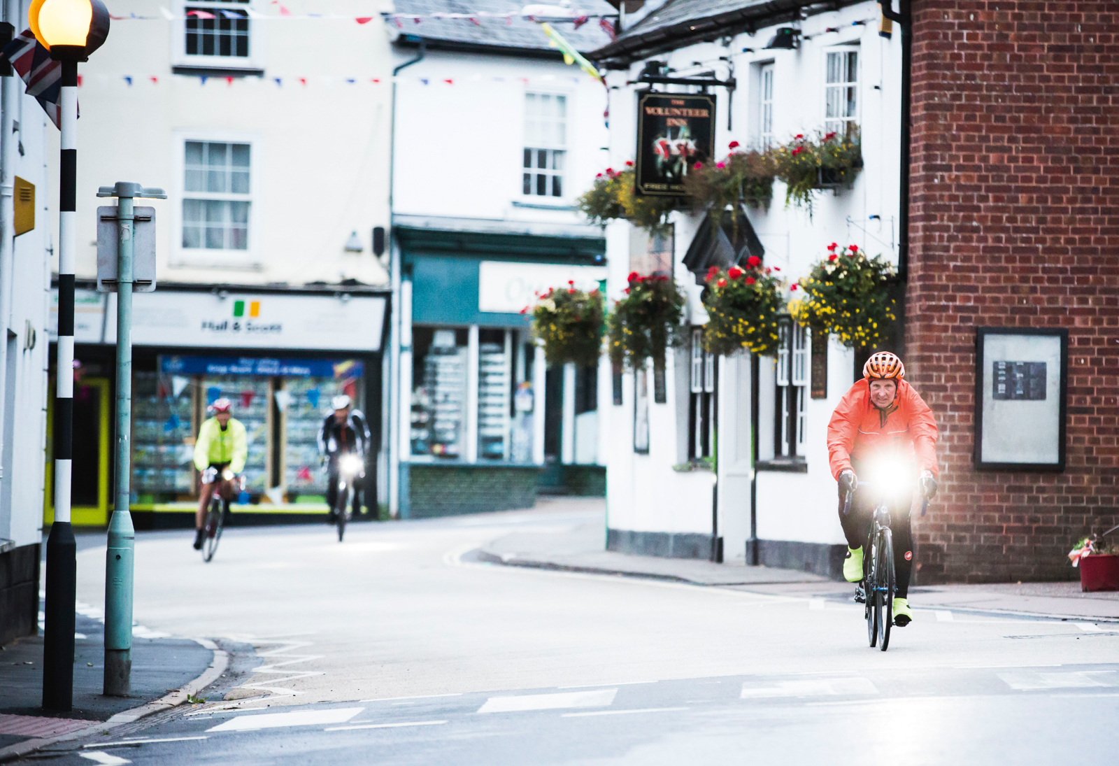Road cyclist riding with daytime lights