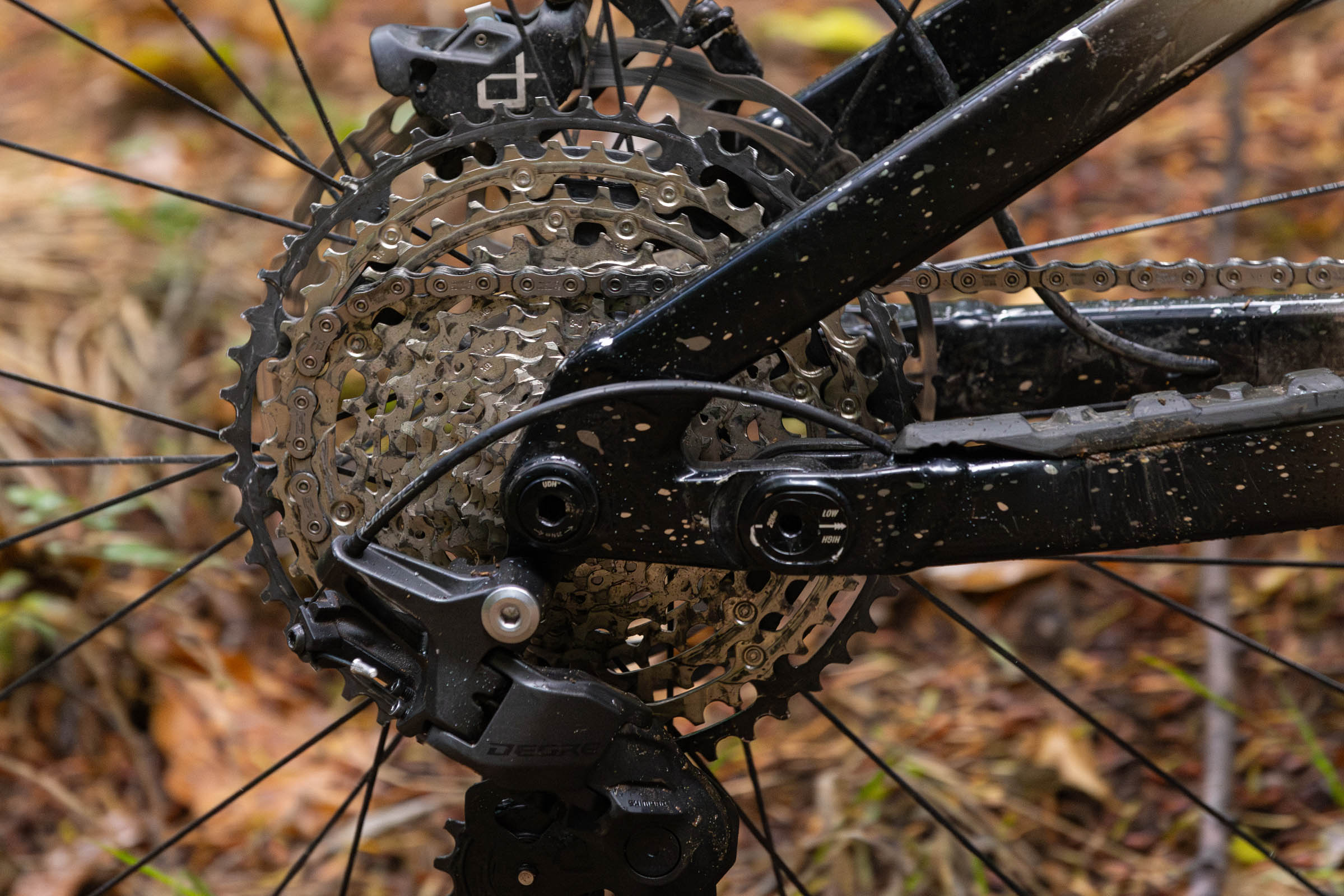 Close-up of a Shimano Deore M7200 rear derailleur and 10-51t cassette on a mountain bike.