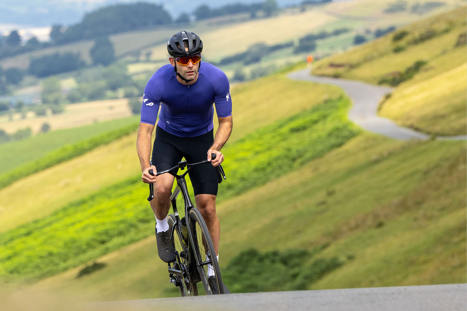 Male cyclist in blue top riding the Cervélo S5 2025 (Dura-Ace Di2) aero road bike