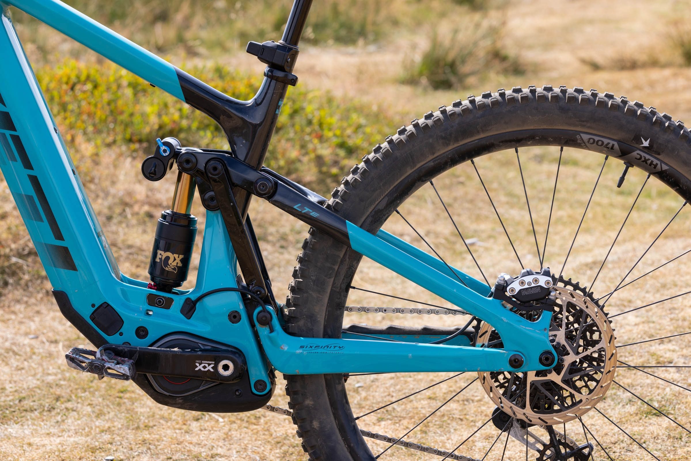 Close-up of the Yeti LTe T4’s Sixfinity suspension linkage, Fox shock and rear brake