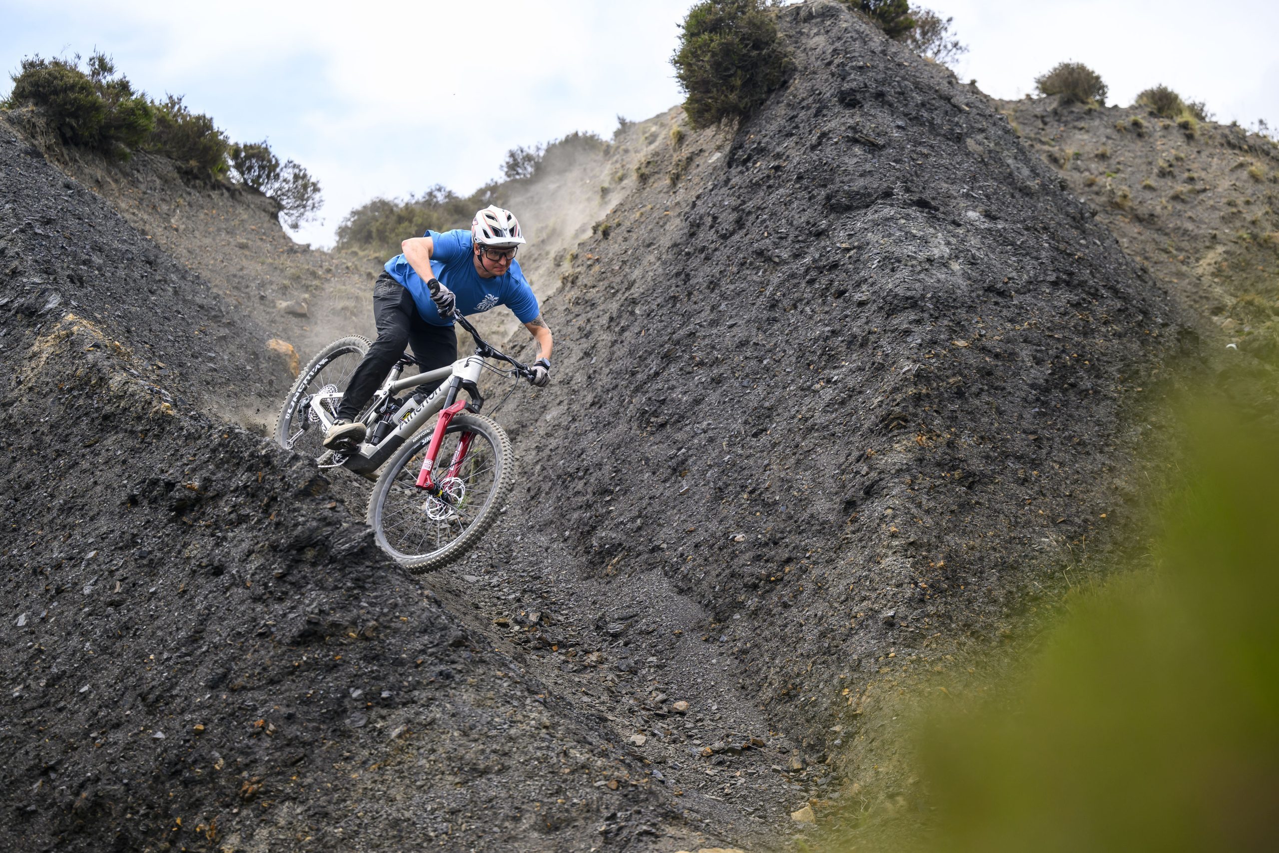 Rider carving through a steep, loose turn on the Atherton S.170E.2 electric mountain bike.