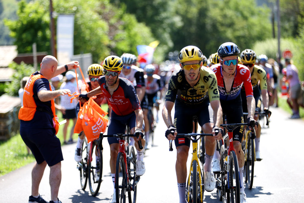 SAINT-GERVAIS MONT-BLANC, FRANCE - JULY 16: Jonathan Castroviejo of Spain and Team INEOS Grenadiers (L) picks food bags from a team soigneur from the team car during the stage fifteen of the 110th Tour de France 2023 a 179km stage from Les Gets les Portes du Soleil to Saint-Gervais Mont-Blanc 1379m / #UCIWT / on July 16, 2023 in Saint-Gervais Mont-Blanc, France.
