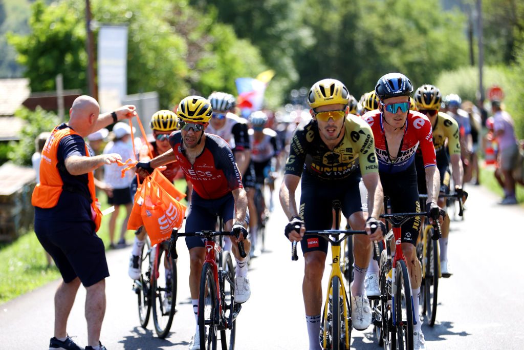 SAINT-GERVAIS MONT-BLANC, FRANCE - JULY 16: Jonathan Castroviejo of Spain and Team INEOS Grenadiers (L) picks food bags from a team soigneur from the team car during the stage fifteen of the 110th Tour de France 2023 a 179km stage from Les Gets les Portes du Soleil to Saint-Gervais Mont-Blanc 1379m / #UCIWT / on July 16, 2023 in Saint-Gervais Mont-Blanc, France.