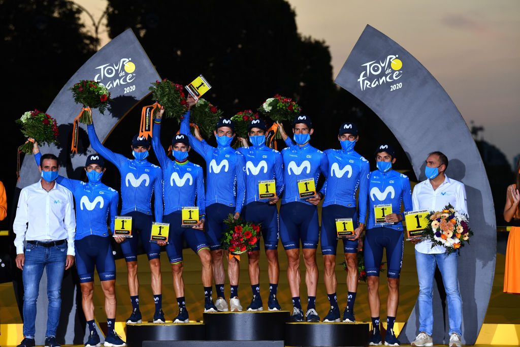 107th Tour de France 2020 - Stage 21 PARIS, FRANCE - SEPTEMBER 20: Podium / Dario Cataldo of Italy, Imanol Erviti of Spain, Enric Mas Nicolau of Spain, Nelson Oliveira of Portugal, Jose Joaquin Rojas Gil of Spain, Marc Soler Gimenez of Spain, Alejandro Valverde Belmonte of Spain, Carlos Verona Quintanilla of Spain and Movistar Team / Jose Luis Arrieta of Spain Sports director of Movistar Team / Pablo Lastras of Spain Sports director of Movistar Team / Best Team / Celebration / Trophy / Flowers / Mask / Covid safety measures / during the 107th Tour de France 2020, Stage 21 a 122km stage from Mantes-La-Jolie to Paris Champs-Élysées / #TDF2020 / @LeTour / on September 20, 2020 in Paris, France. (Photo by Stuart Franklin/Getty Images,)