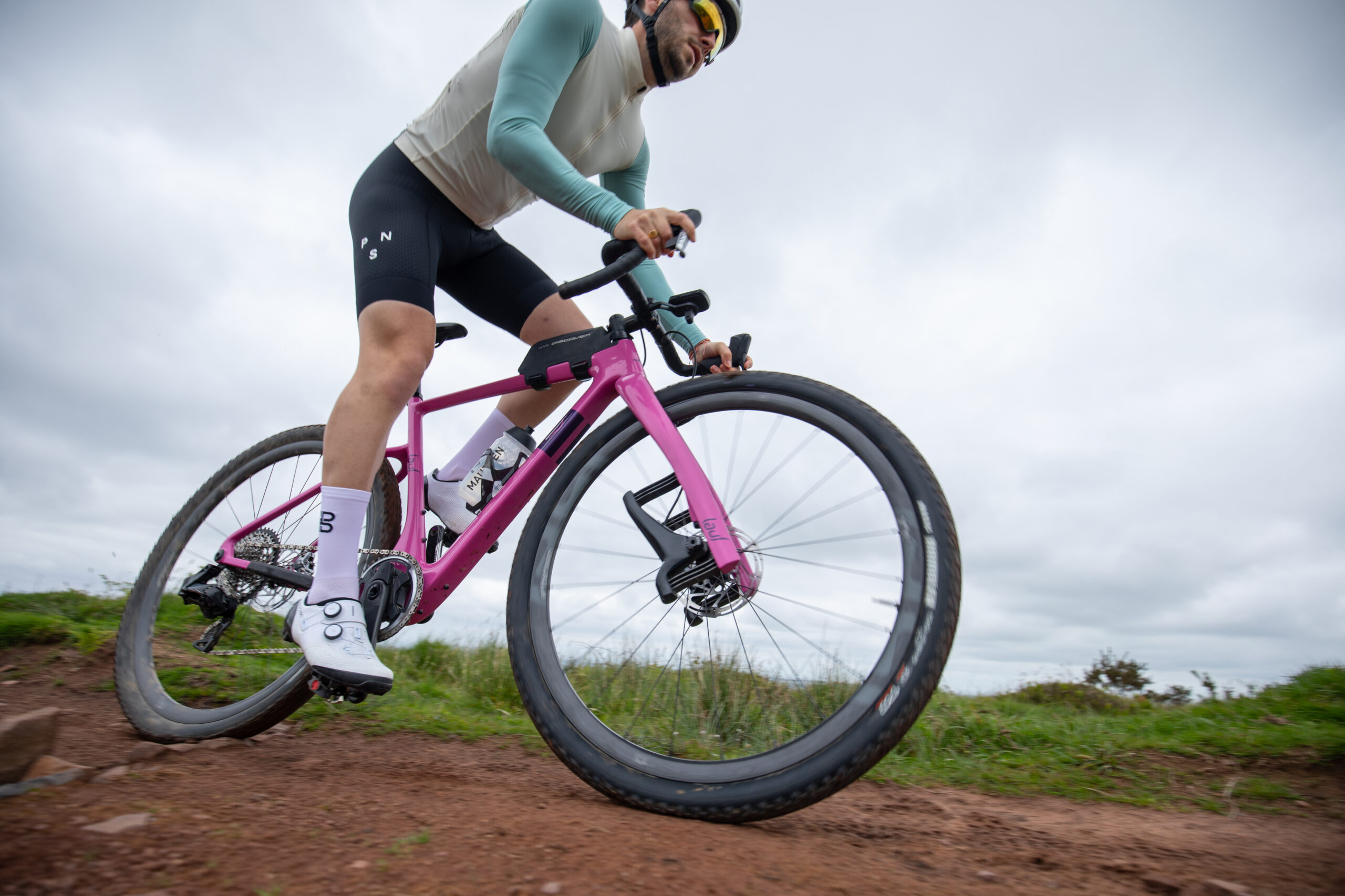 Liam Cahill sprinting on pink Lauf gravel bike
