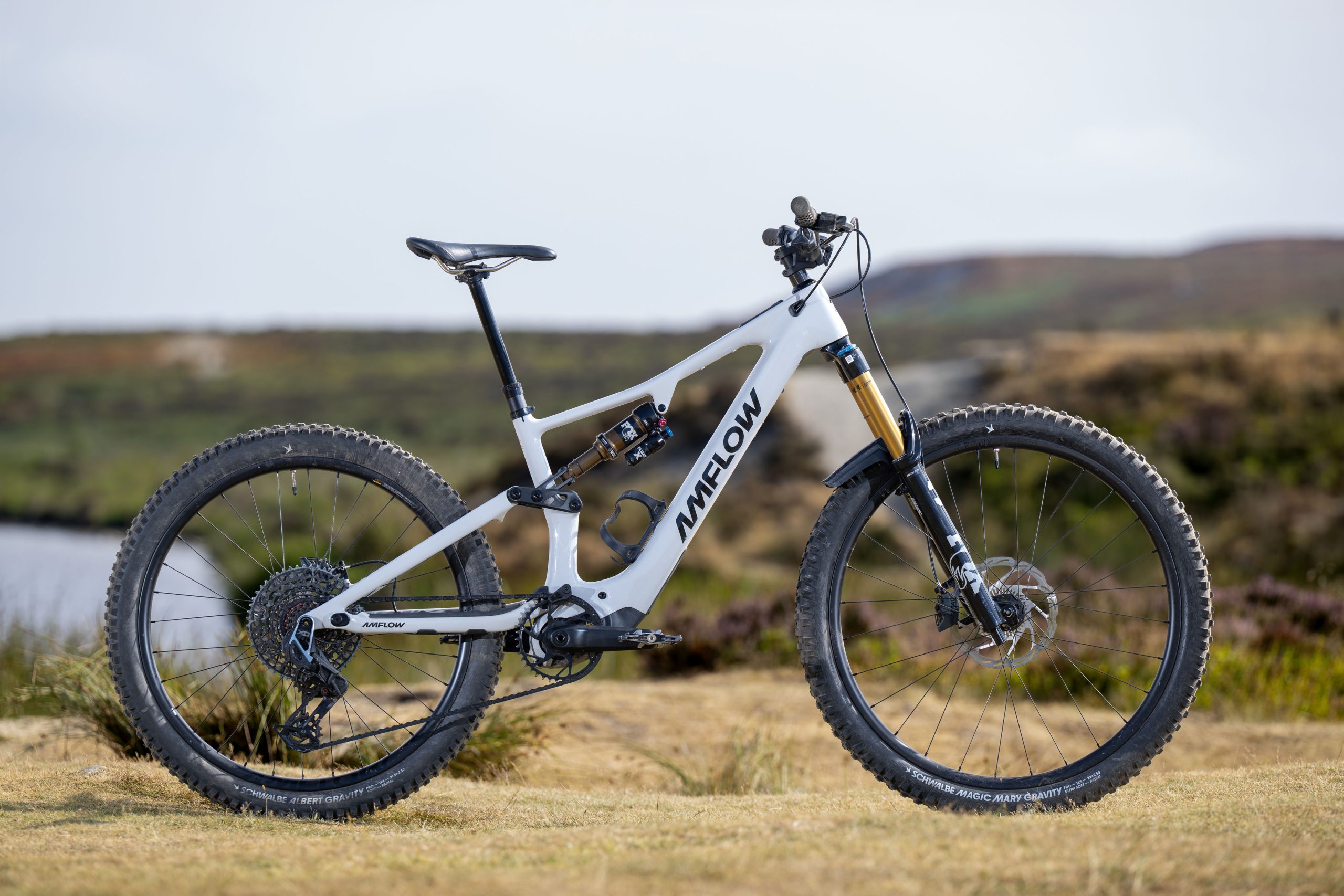 White Amflow PX Carbon Pro electric mountain bike shown in side profile with Fox Factory suspension and carbon wheels