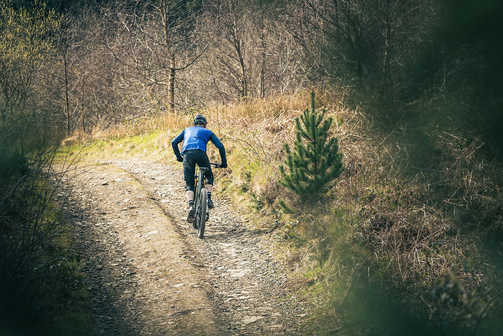 Male cyclist riding the Vitus Escarpe 29 CRX full suspension mountain bike
