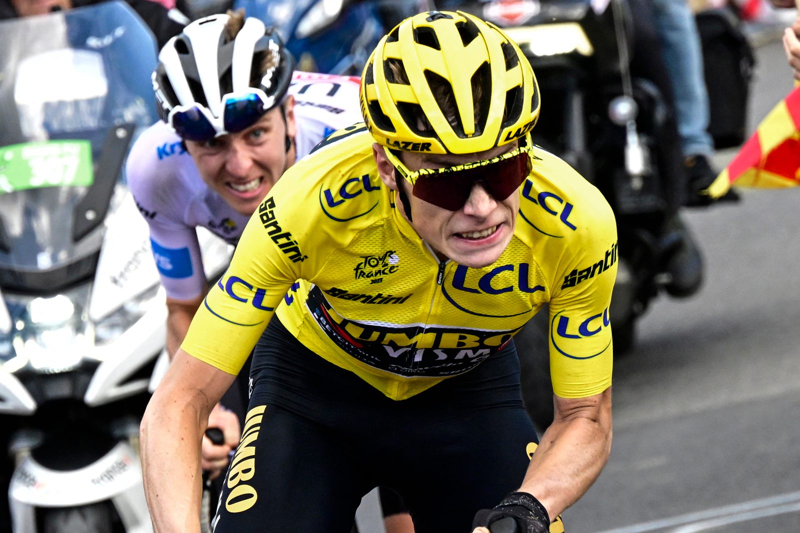 Jumbo-Visma's Danish rider Jonas Vingegaard wearing the overall leader's yellow jersey cycles ahead of UAE Team Emirates' Slovenian rider Tadej Pogacar.